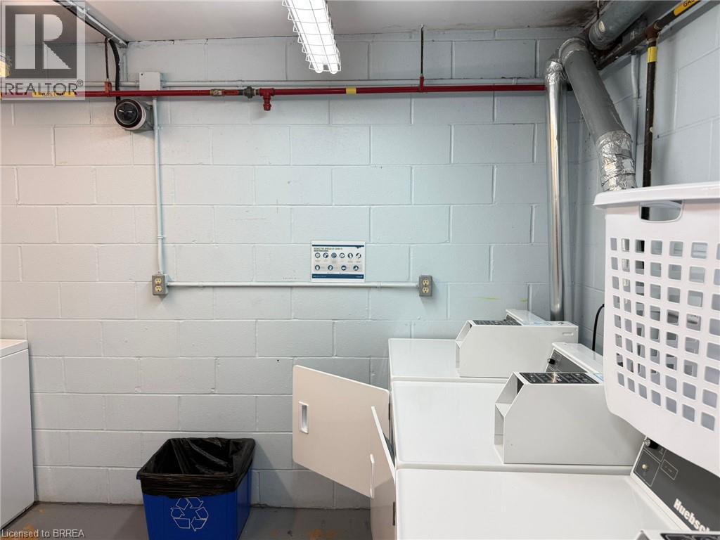 On-site laundry facilities with multiple washing machines - 12 Bridgeport Road E Unit# 18, Waterloo, ON