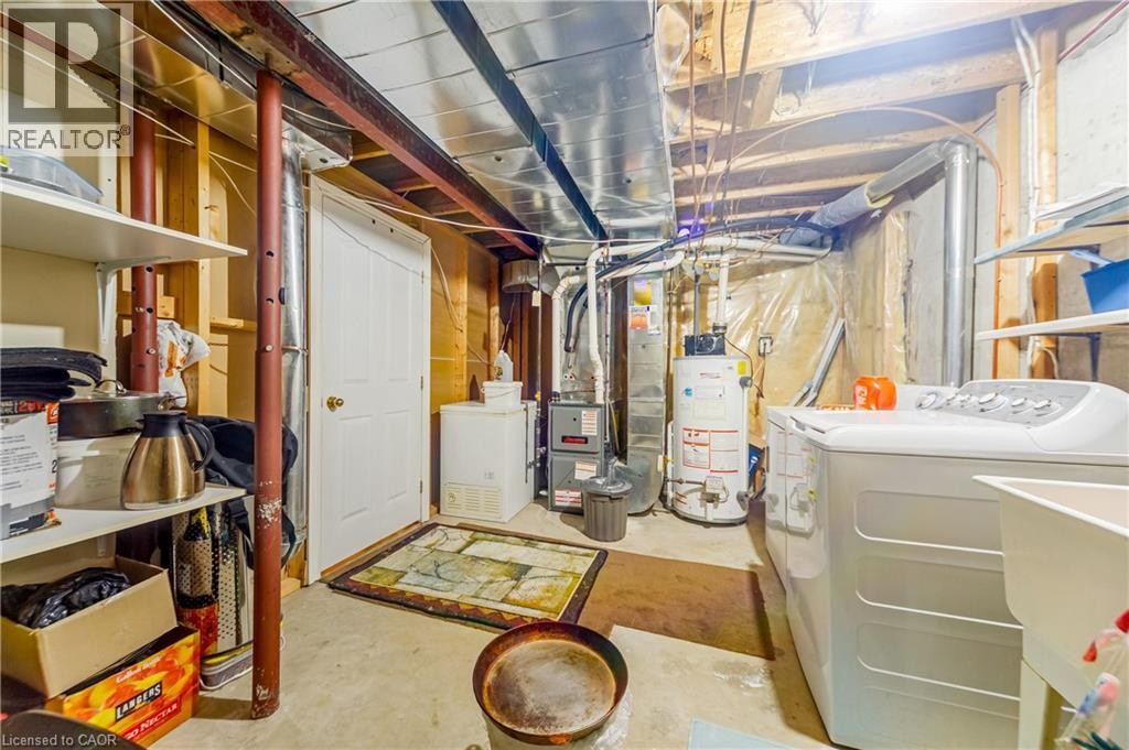 Full-size laundry area with utility sink, water heater, and furnace - 82 Milner Downs Crescent, Ottawa, ON