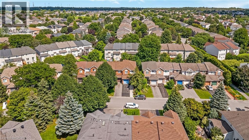 Residential neighborhood featuring a consistent architectural style, mature trees, and paved roadways - 82 Milner Downs Crescent, Ottawa, ON