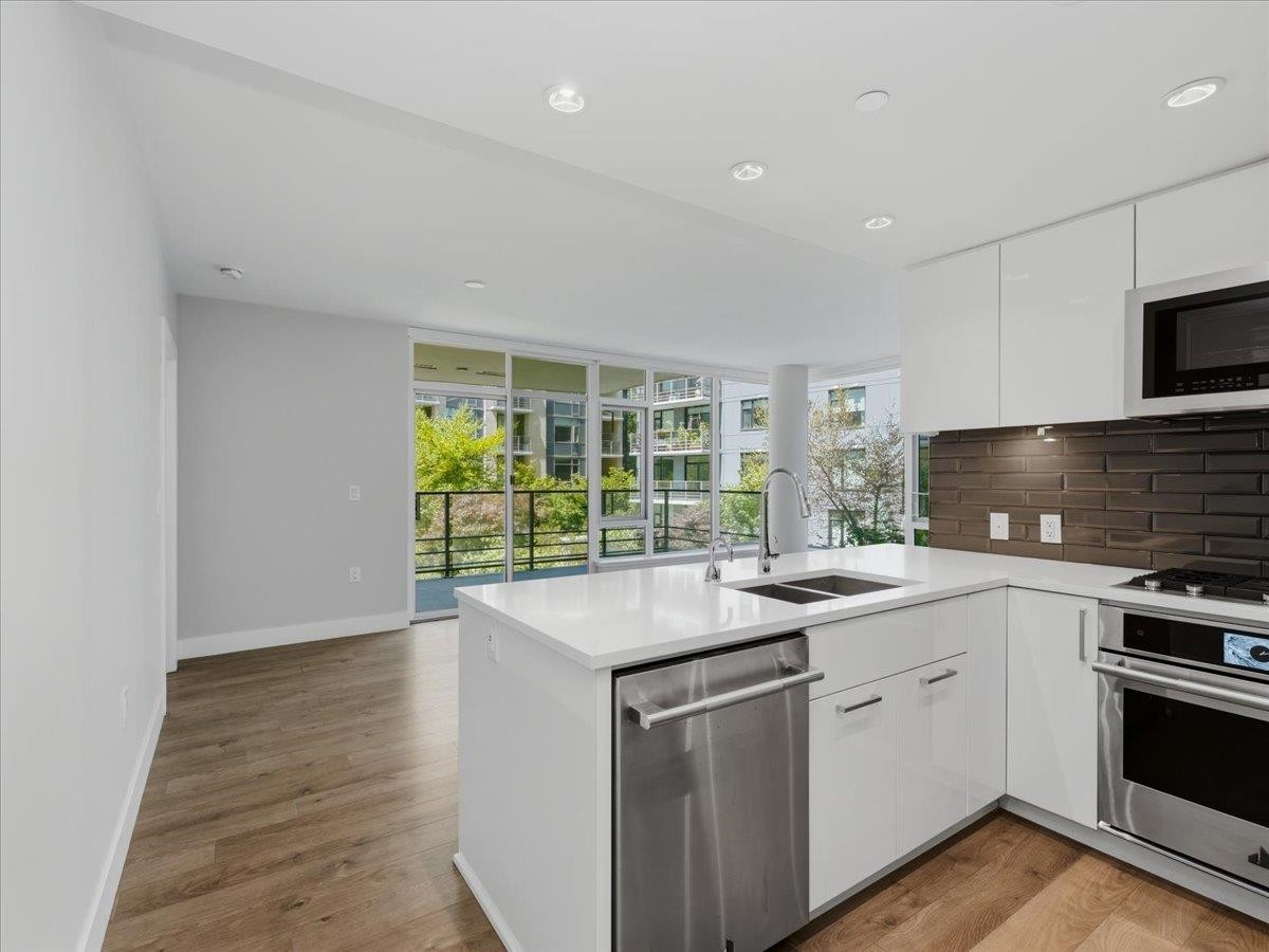 302-8533 River District Crossing, Vancouver, BC - Indoor Photo Showing Kitchen With Stainless Steel Kitchen With Double Sink With Upgraded Kitchen