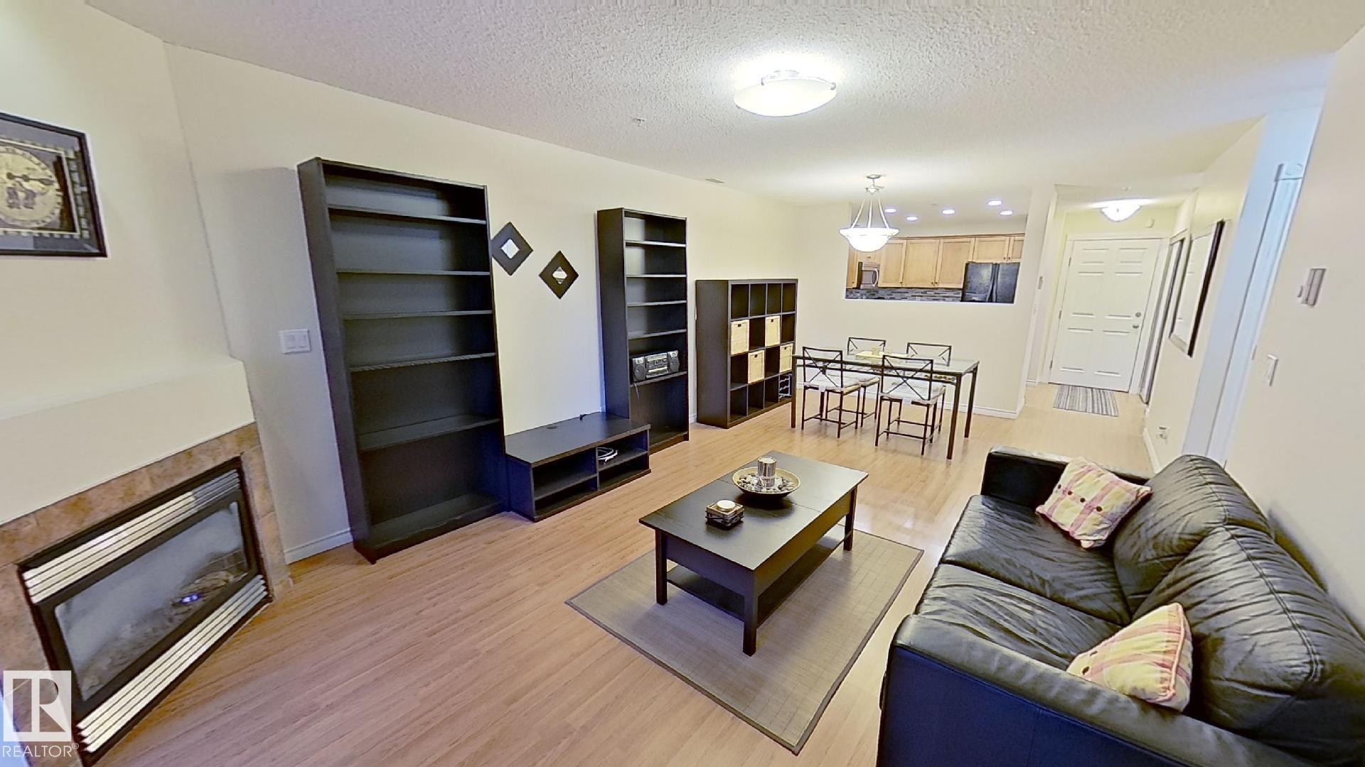 119 12110 106 Avenue Nw, Edmonton, AB - Indoor Photo Showing Living Room With Fireplace