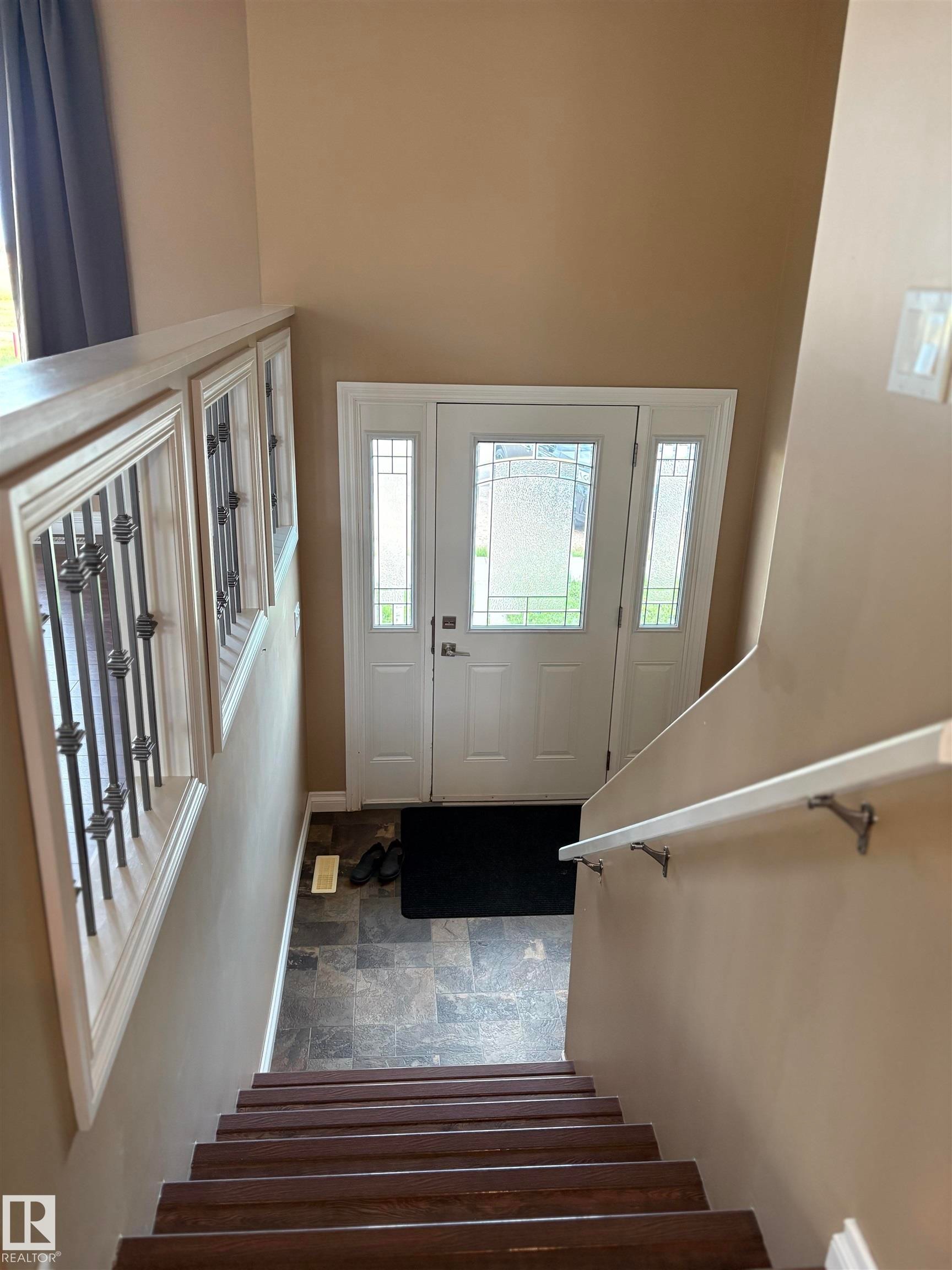 Entryway with stairway, and plenty of natural light - 5302 Railway Avenue, Elk Point, AB - Indoor Photo Showing Other Room