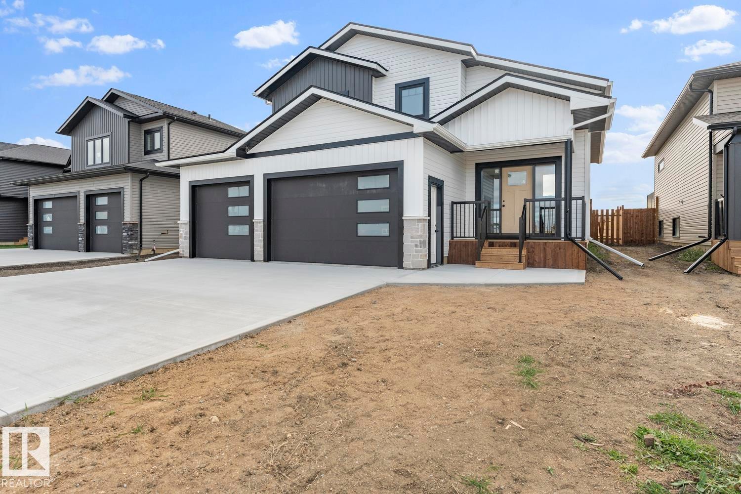 View of front of house with driveway and board and batten siding - 807 Schooner Drive, Cold Lake, AB - Outdoor