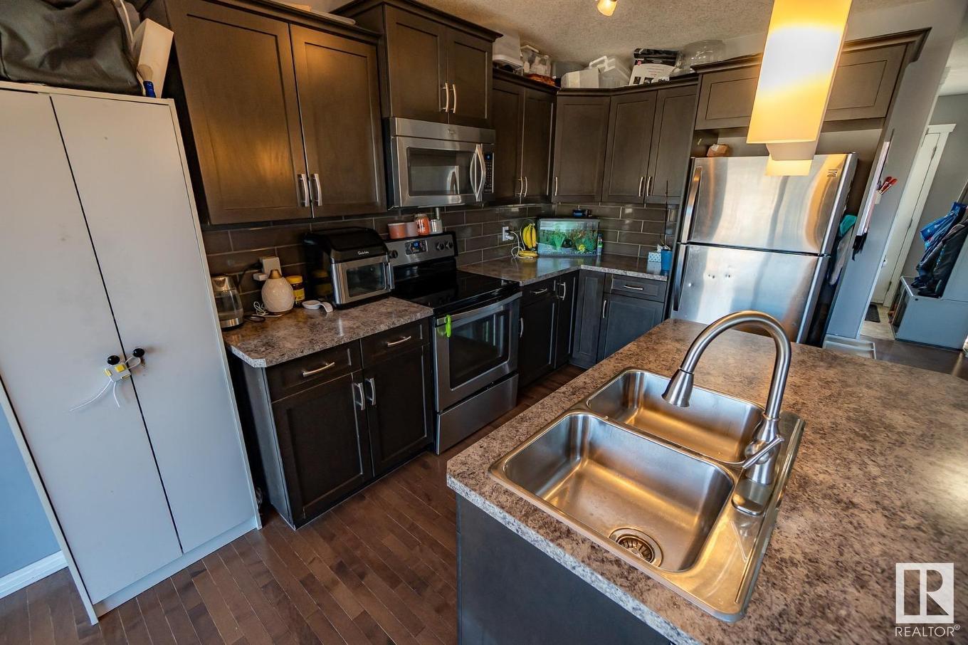 #20 Spruce Boulevard, Leduc, AB - Indoor Photo Showing Kitchen With Stainless Steel Kitchen With Double Sink