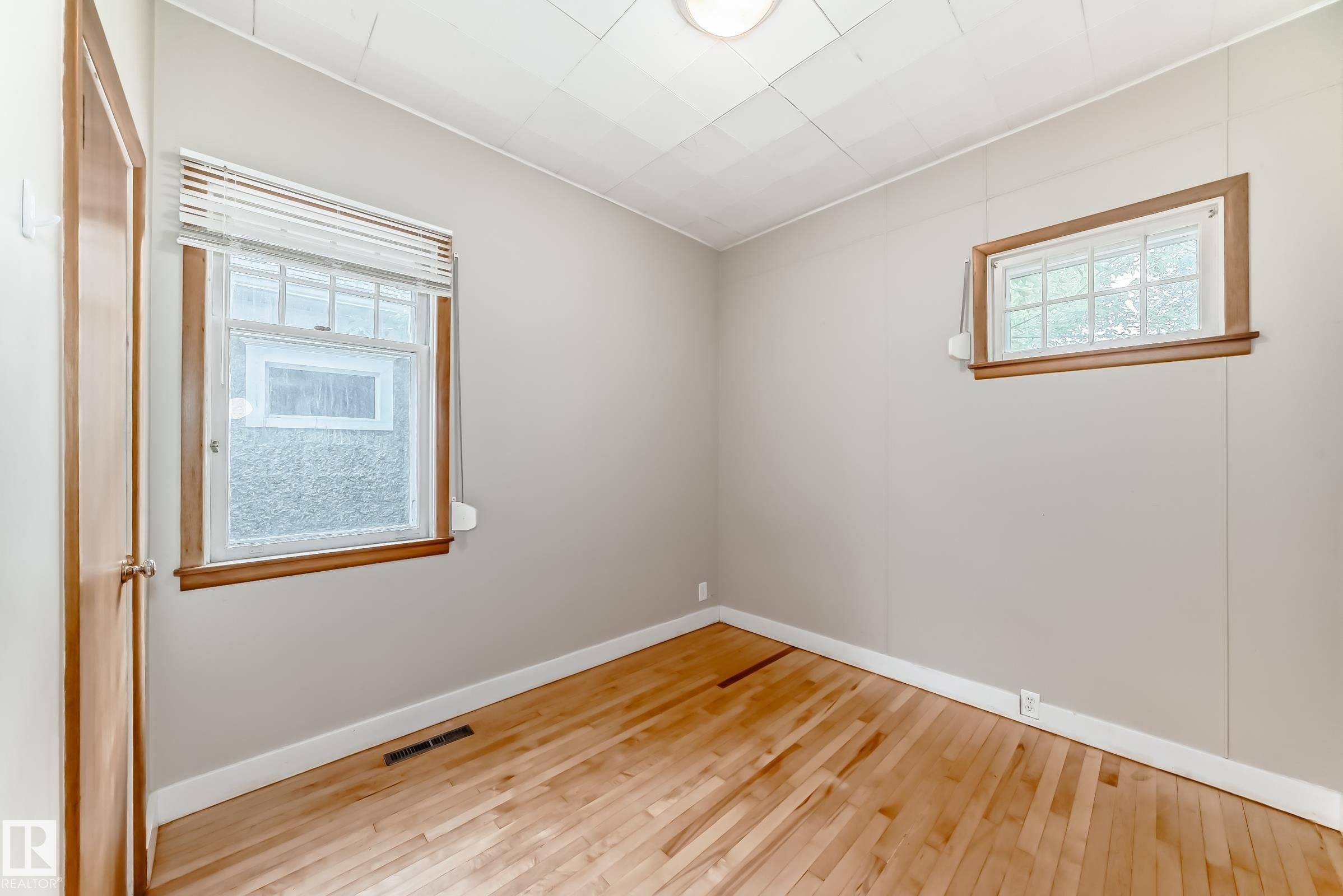 Bedroom with wood-type flooring and baseboards - 12605 107 Avenue, Edmonton, AB - Indoor Photo Showing Other Room