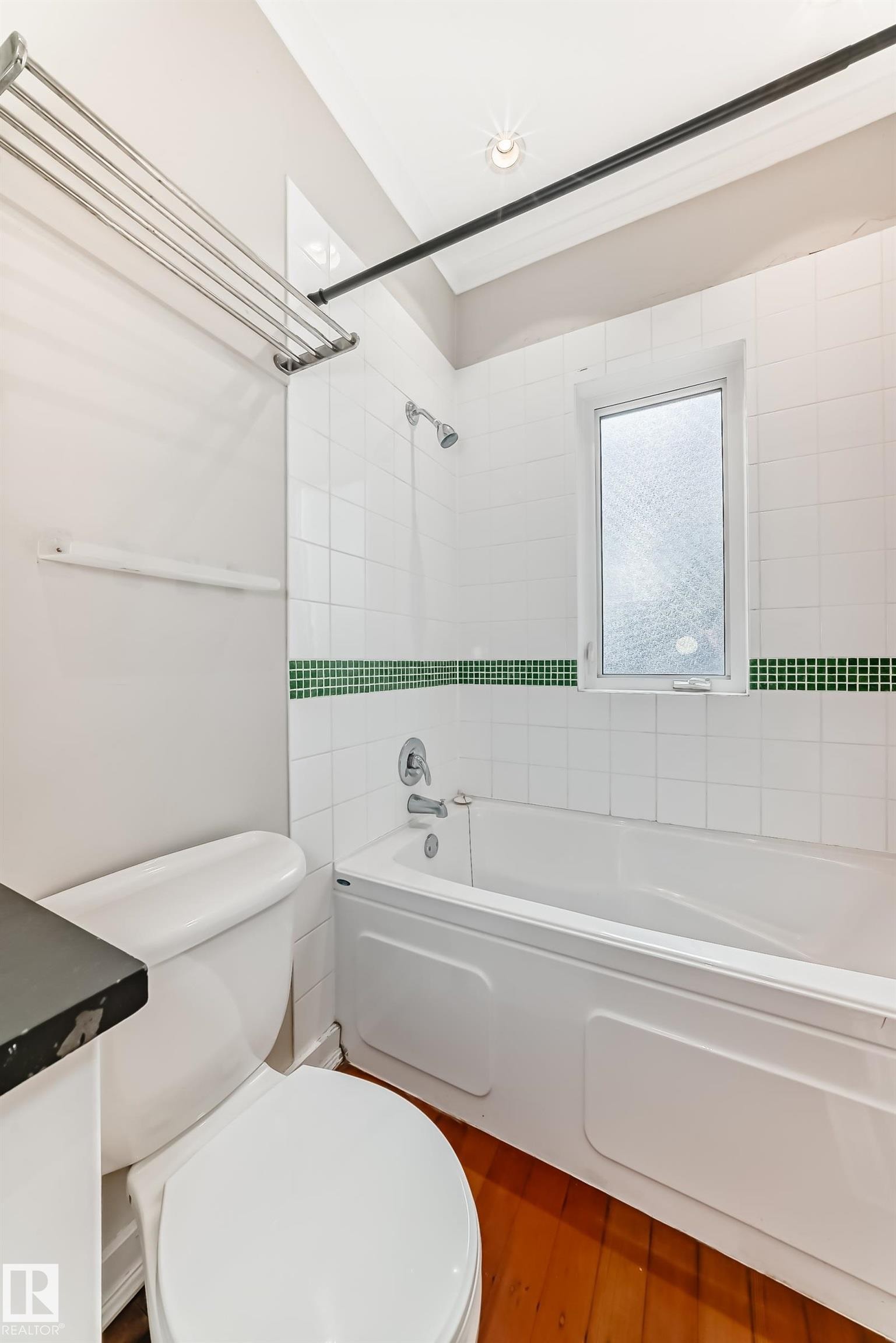 Full bathroom featuring bathing tub / shower combination, wood finished floors, and vanity - 12605 107 Avenue, Edmonton, AB - Indoor Photo Showing Bathroom