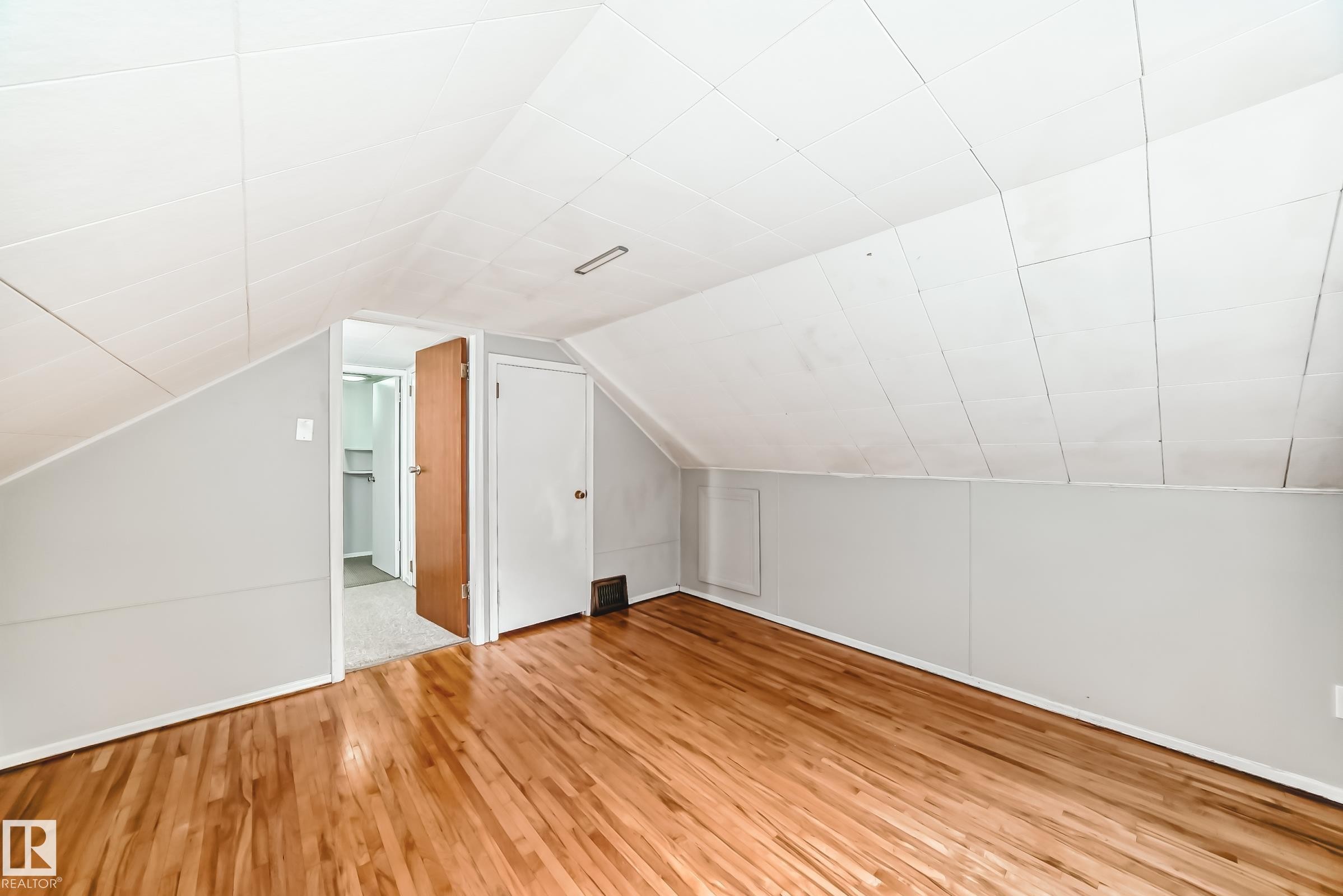 Bed room with light wood-style floors and lofted ceiling - 12605 107 Avenue, Edmonton, AB - Indoor Photo Showing Other Room