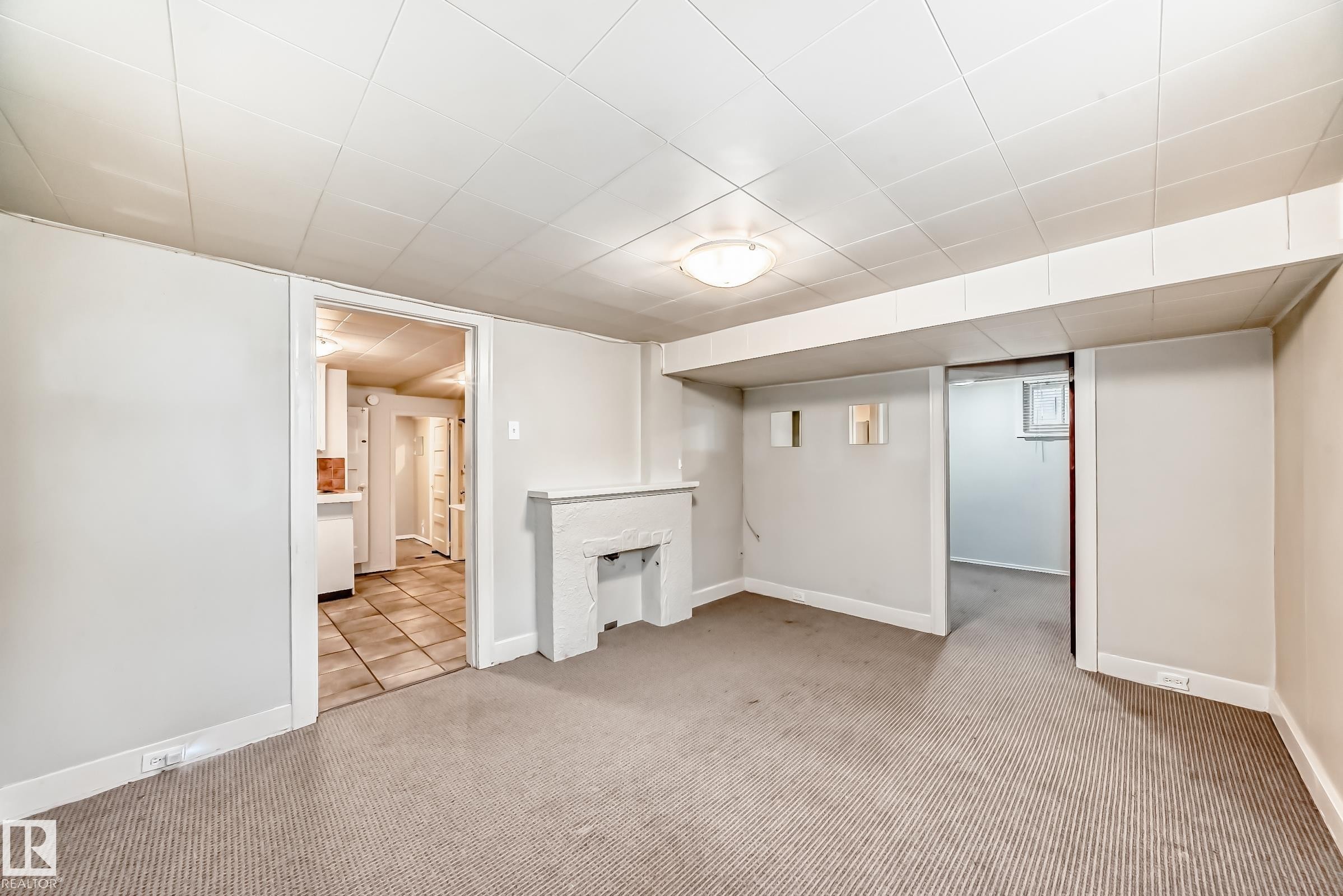 Finished basement featuring light carpet and a drop ceiling - 12605 107 Avenue, Edmonton, AB - Indoor