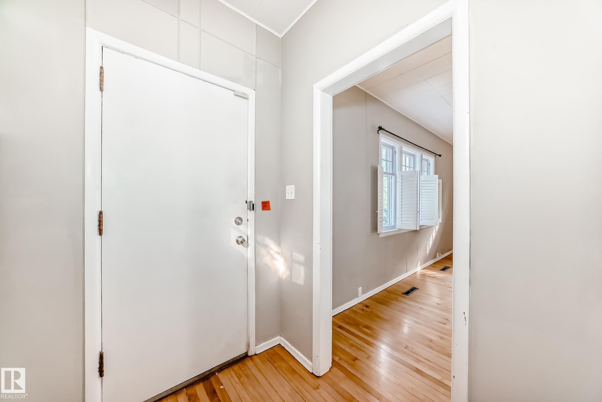 Foyer entrance featuring light wood-style floors and baseboards - 12605 107 Avenue, Edmonton, AB - Indoor Photo Showing Other Room