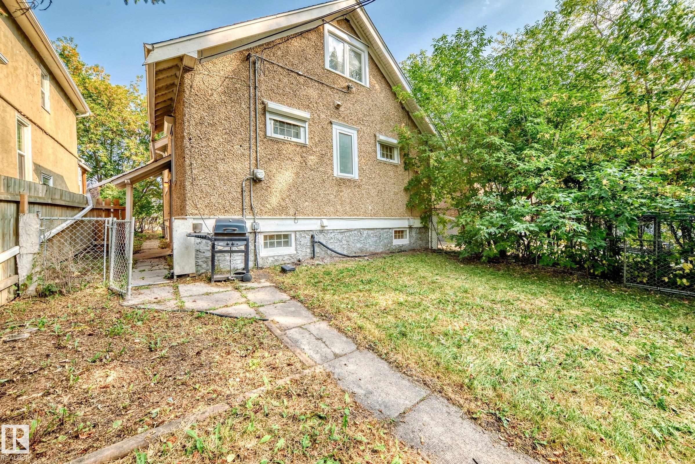 Rear view of property with a fenced backyard - 12605 107 Avenue, Edmonton, AB - Outdoor