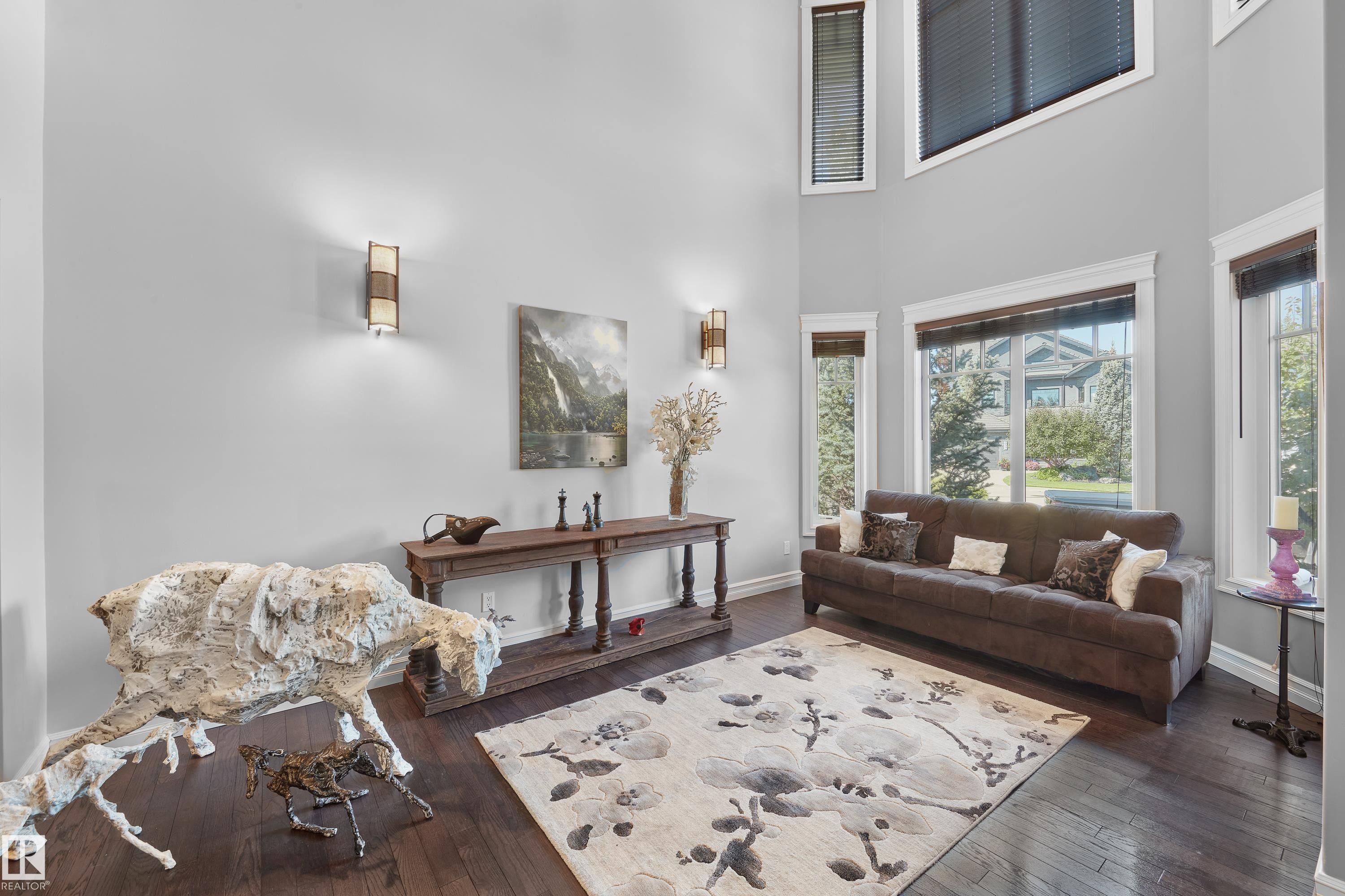 Living area with hardwood / wood-style floors, plenty of natural light, and a high ceiling - 4111 Westcliff Heath Heath, Edmonton, AB - Indoor Photo Showing Living Room