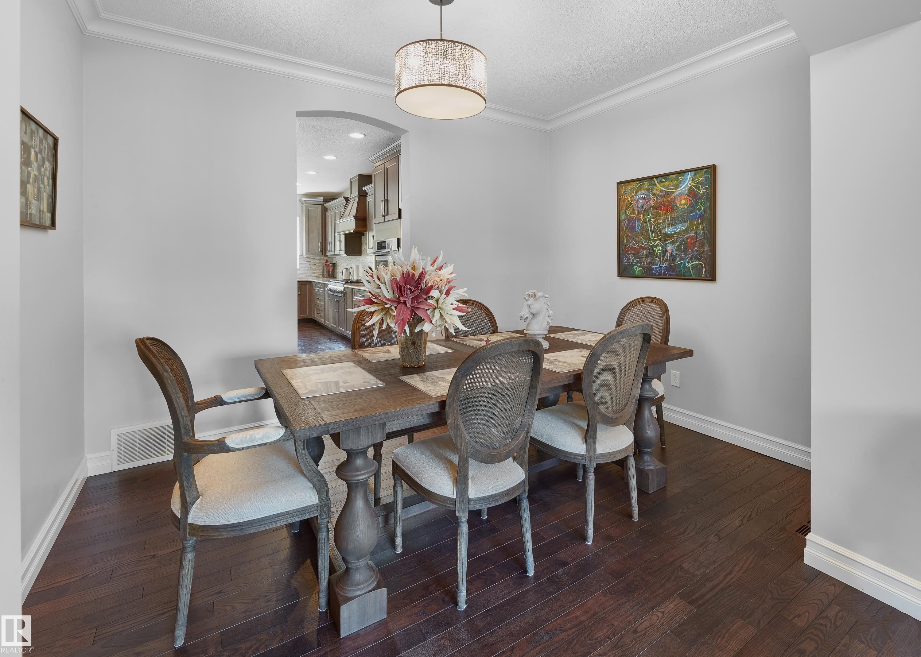 Dining area with ornamental molding, dark wood-style floors, arched walkways, and recessed lighting - 4111 Westcliff Heath Heath, Edmonton, AB - Indoor Photo Showing Dining Room