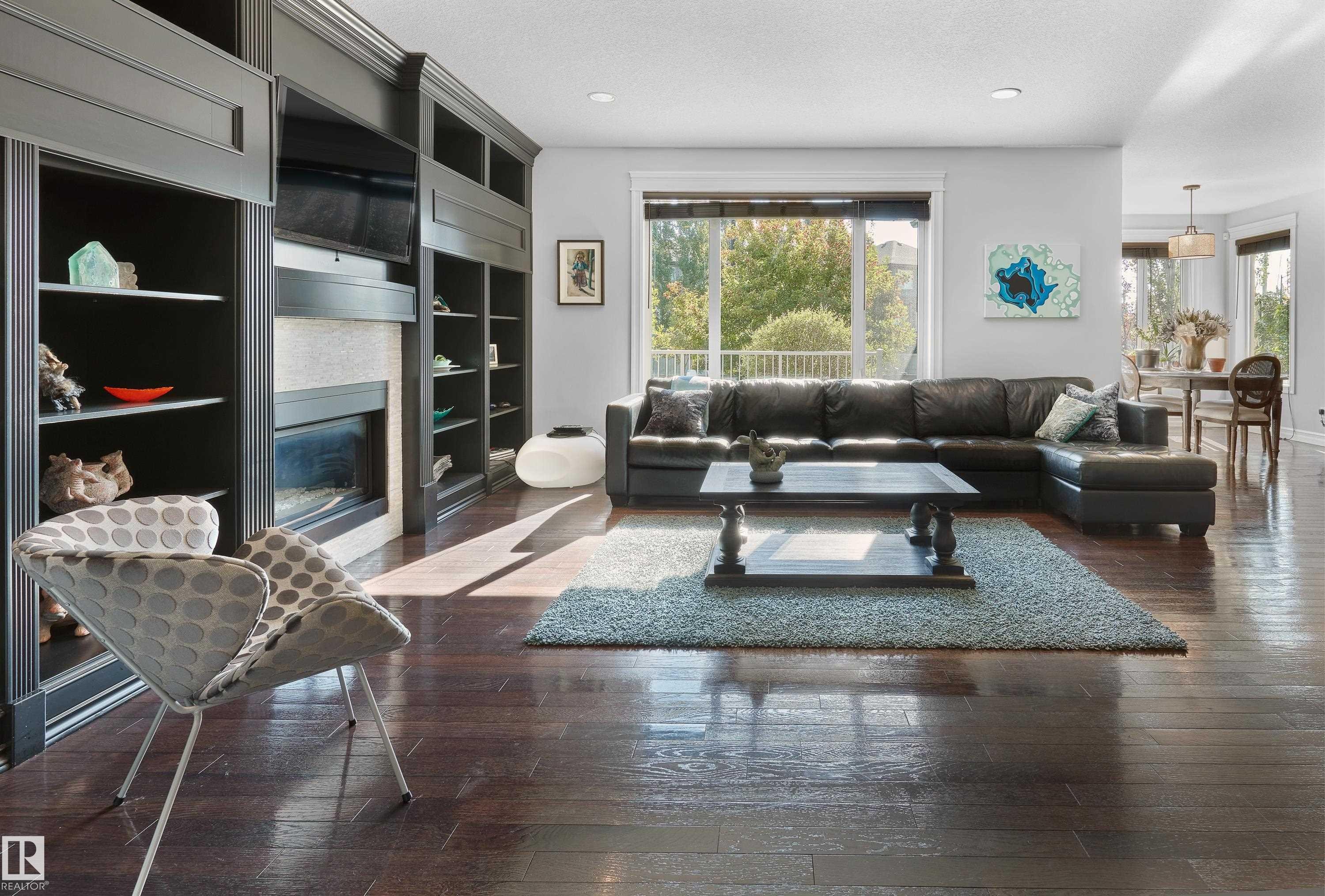 Living room featuring hardwood / wood-style floors, a textured ceiling, a tiled fireplace, and recessed lighting - 4111 Westcliff Heath Heath, Edmonton, AB - Indoor Photo Showing Living Room With Fireplace