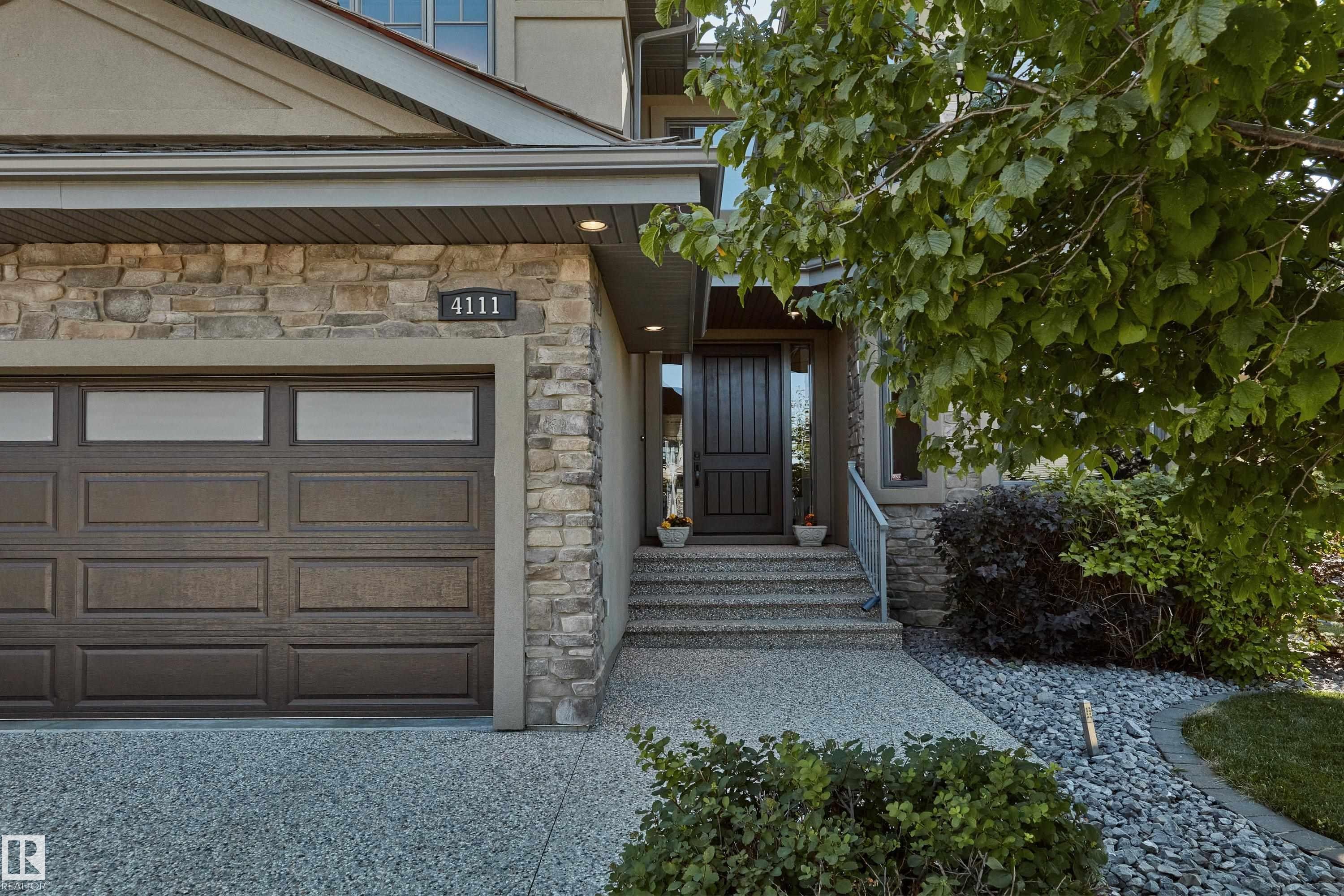 View of exterior entry featuring stone siding and an attached garage - 4111 Westcliff Heath Heath, Edmonton, AB - Outdoor