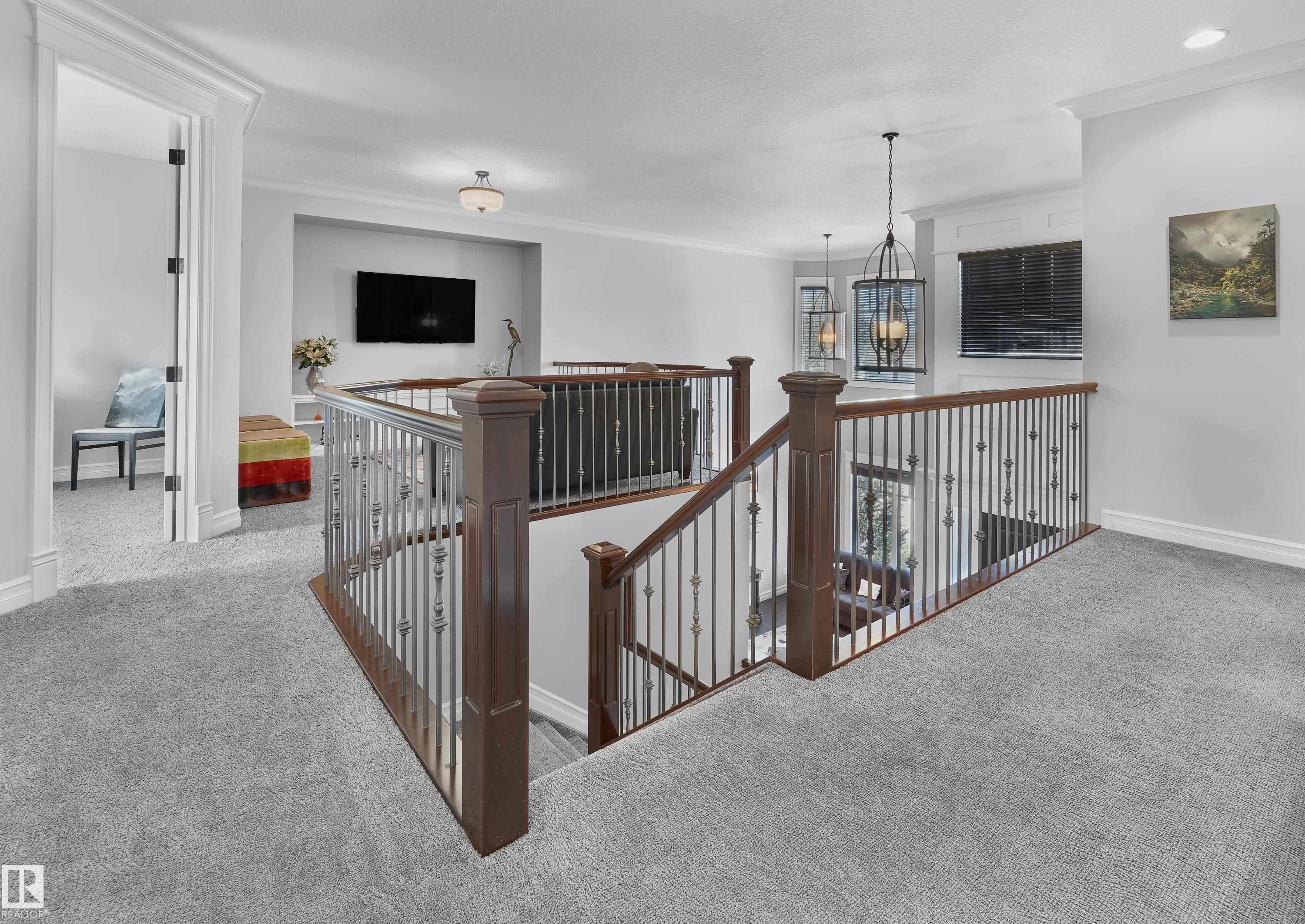 Hall with an upstairs landing, carpet floors, crown molding, and a chandelier - 4111 Westcliff Heath Heath, Edmonton, AB - Indoor Photo Showing Other Room