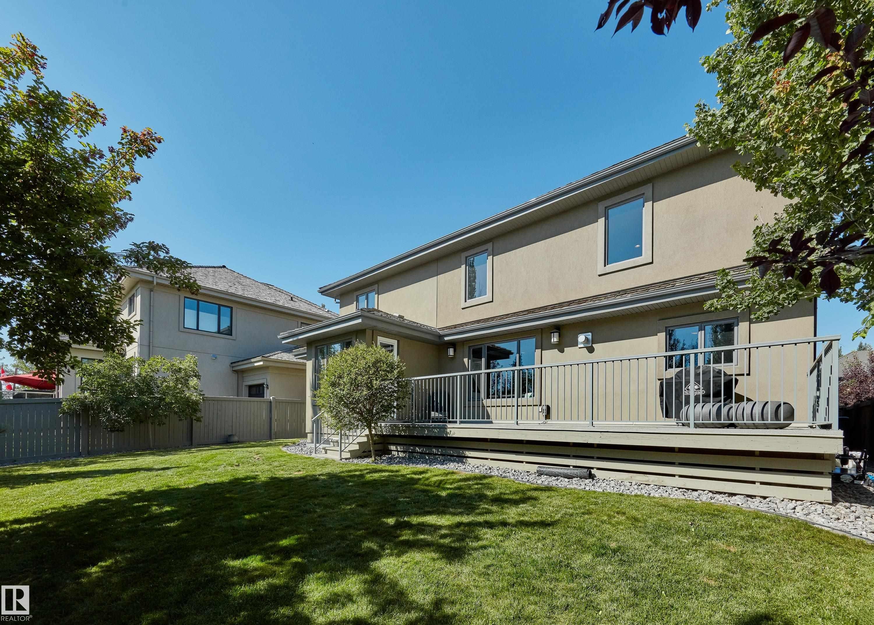 Rear view of property featuring stucco siding and a wooden deck - 4111 Westcliff Heath Heath, Edmonton, AB - Outdoor With Deck Patio Veranda