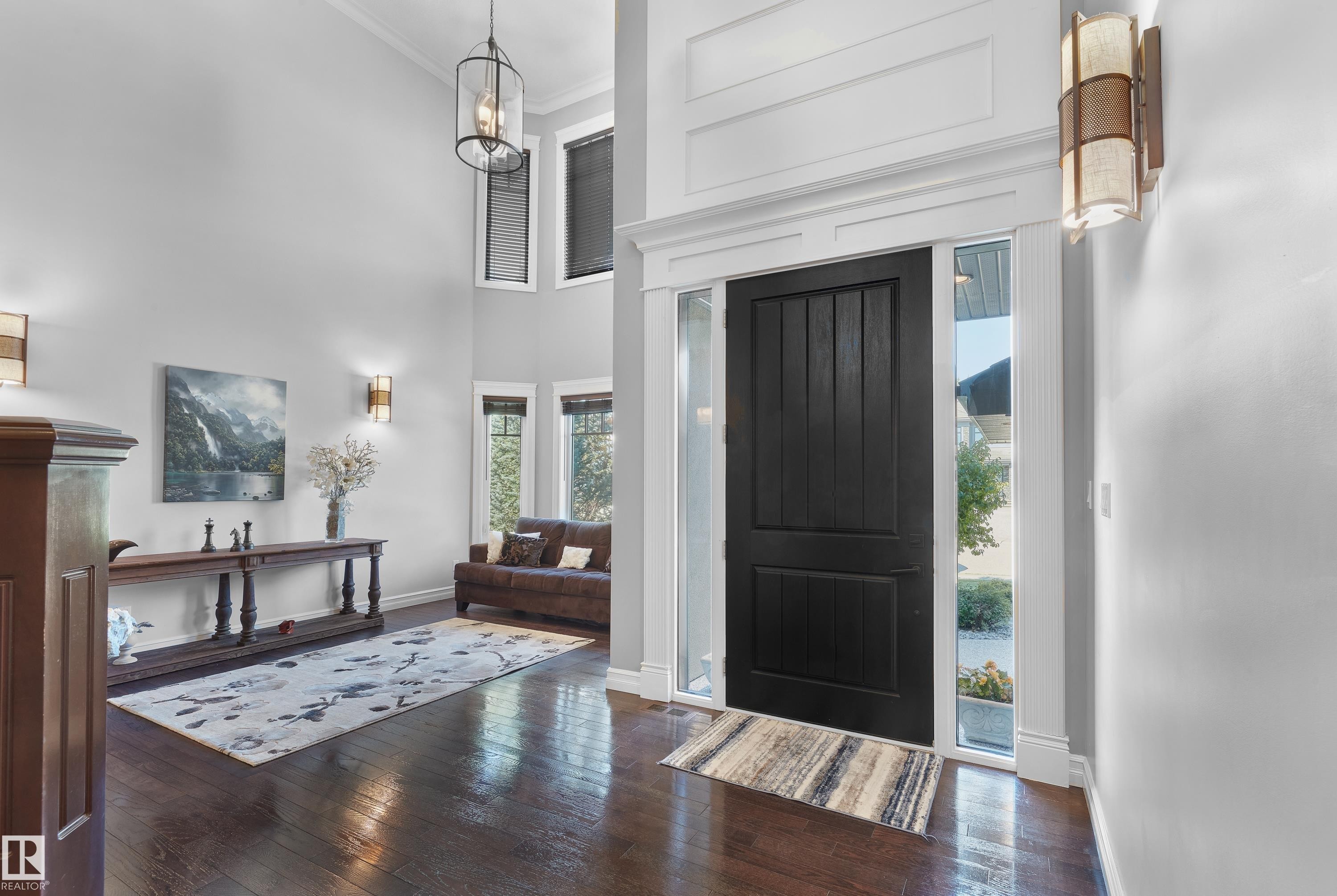 Foyer featuring crown molding, wood-type flooring, a high ceiling, and a chandelier - 4111 Westcliff Heath Heath, Edmonton, AB - Indoor