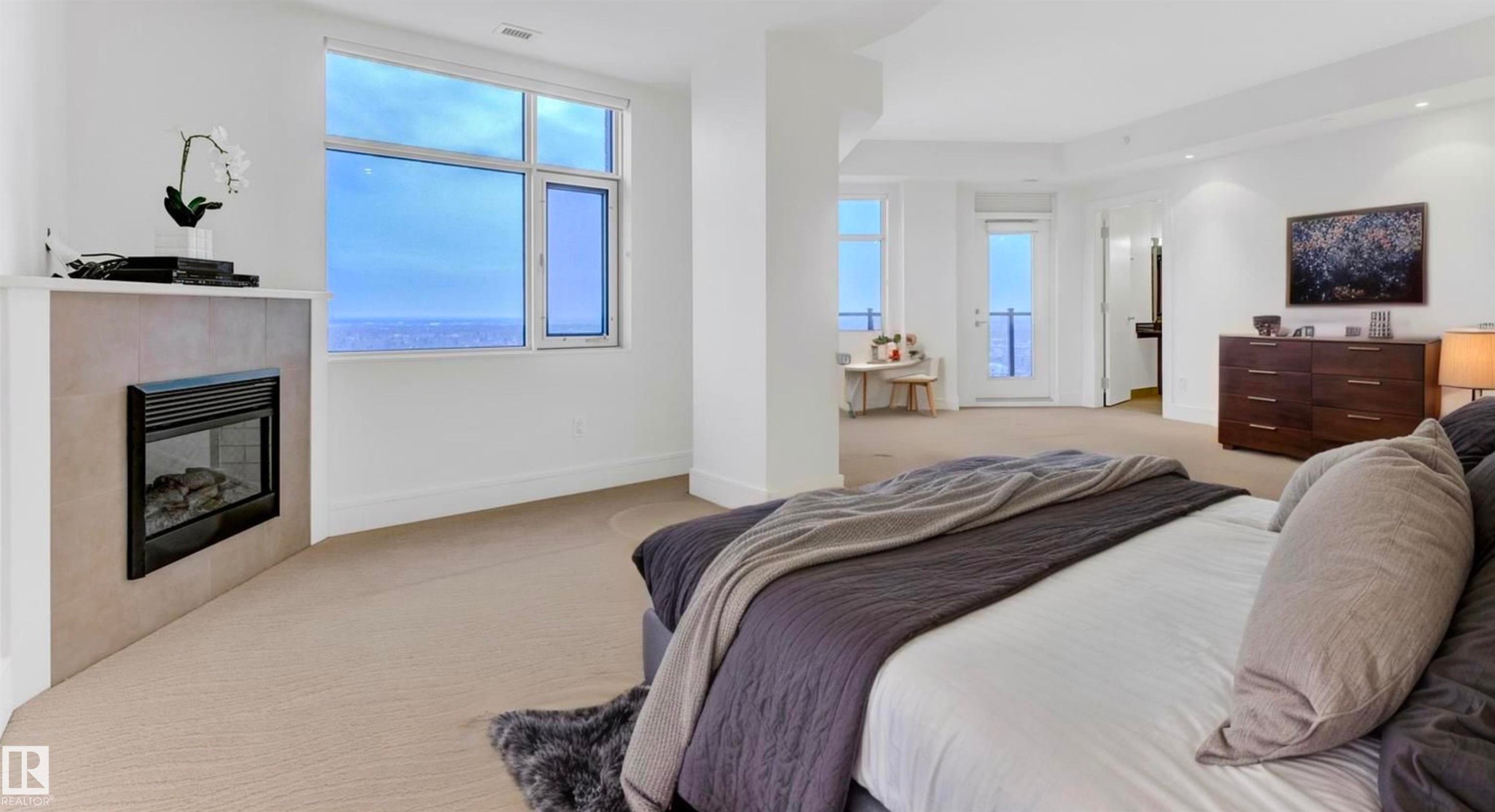 1900 10035 Saskatchewan Drive, Edmonton, AB - Indoor Photo Showing Bedroom With Fireplace