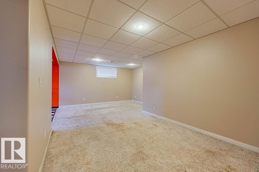 Basement featuring a drop ceiling and carpet flooring - 5026 53 Ave, Ryley, AB - Indoor