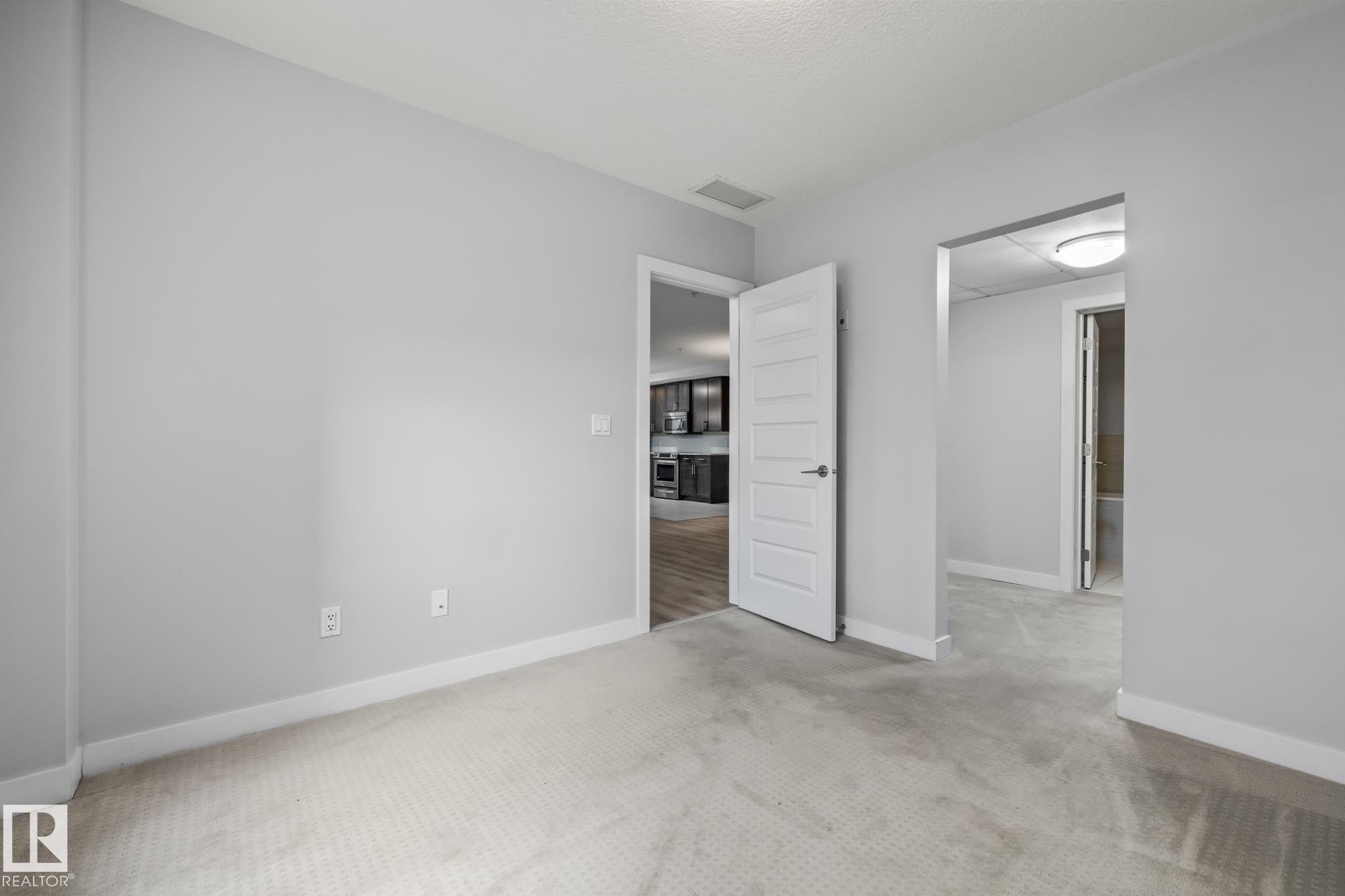 Unfurnished bedroom with carpet and baseboards - 810 5151 Windermere Boulevard, Edmonton, AB - Indoor
