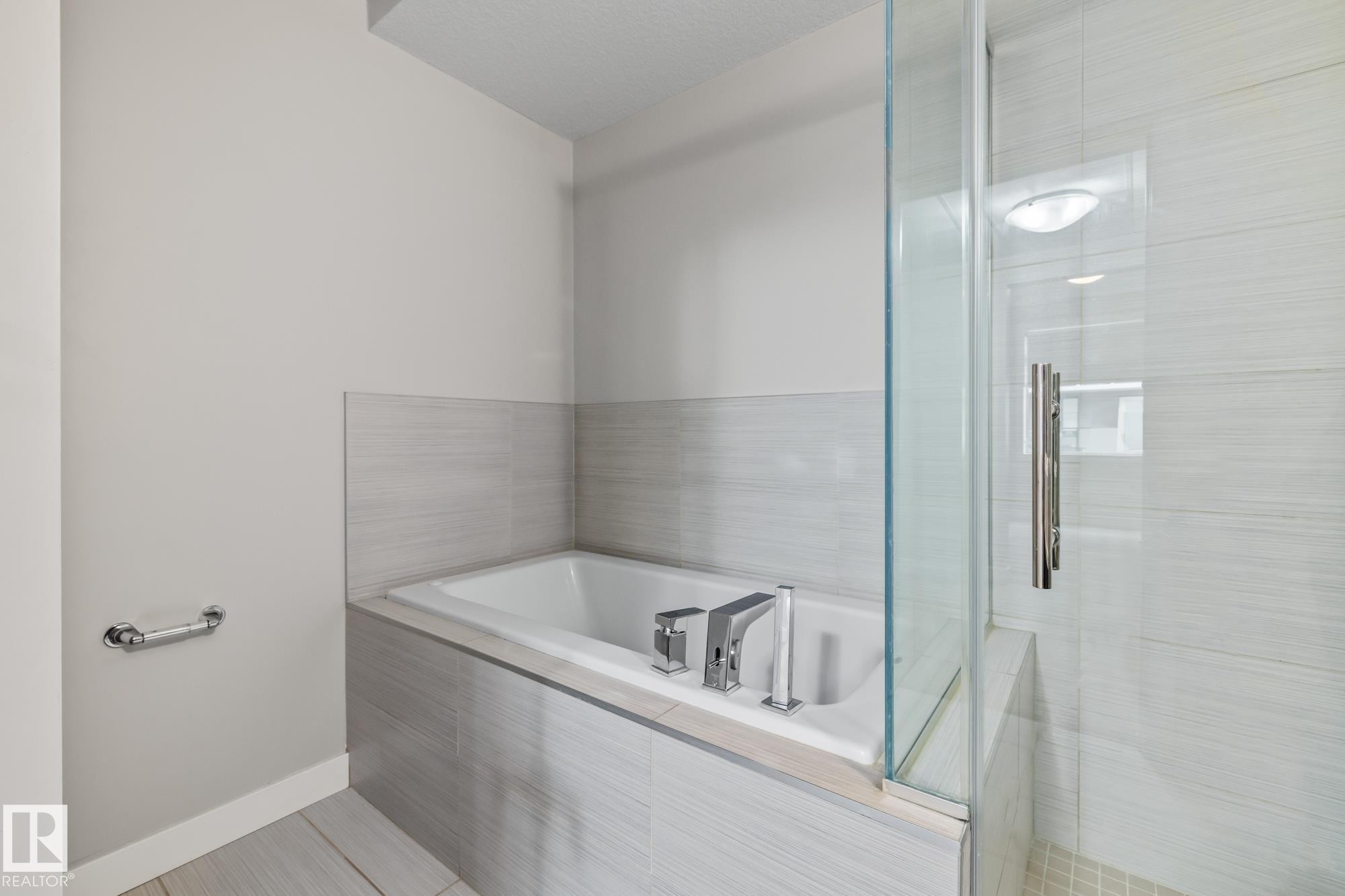 Full bath with a bath and a stall shower - 810 5151 Windermere Boulevard, Edmonton, AB - Indoor Photo Showing Bathroom
