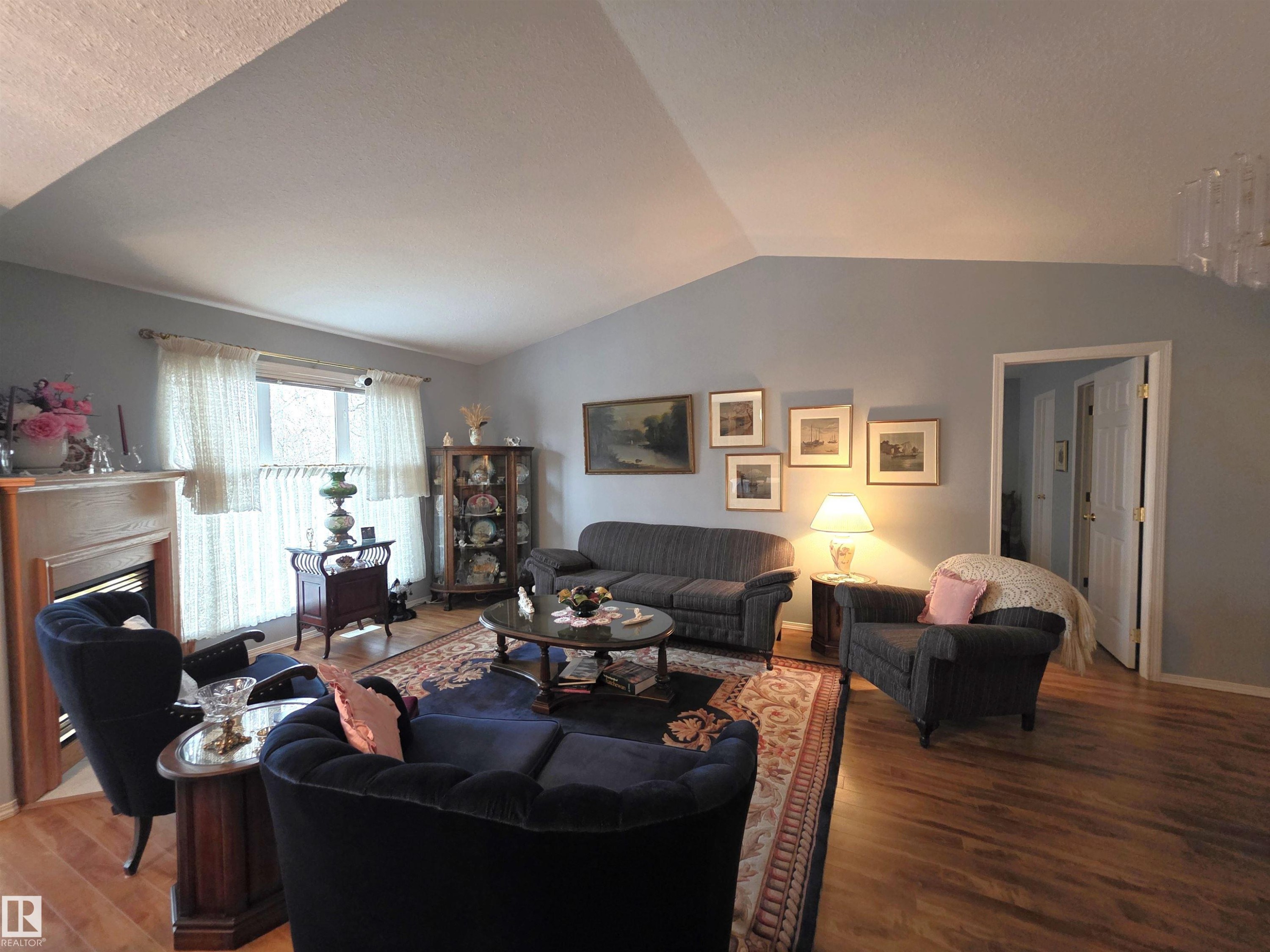 208 Ravine Villa(S), Leduc, AB - Indoor Photo Showing Living Room With Fireplace