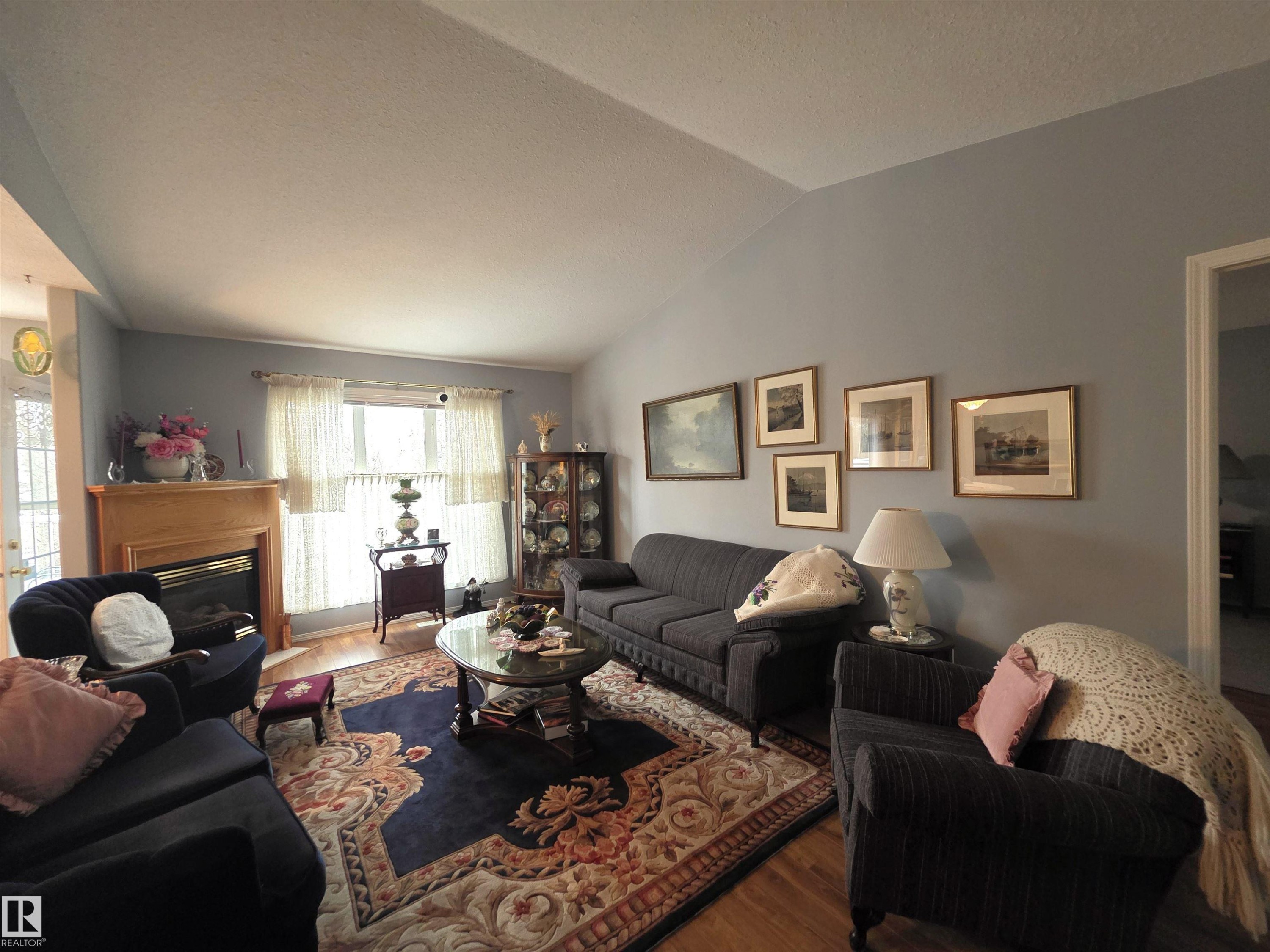 208 Ravine Villa(S), Leduc, AB - Indoor Photo Showing Living Room With Fireplace