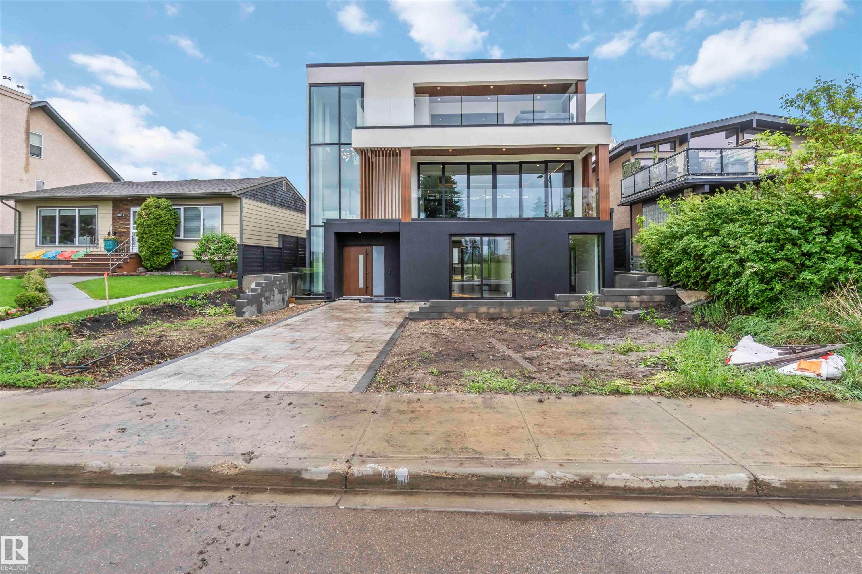 Contemporary multi-level residence featuring a sleek facade with expansive glazing - 8915 Strathearn Drive, Edmonton, AB - Outdoor With Facade