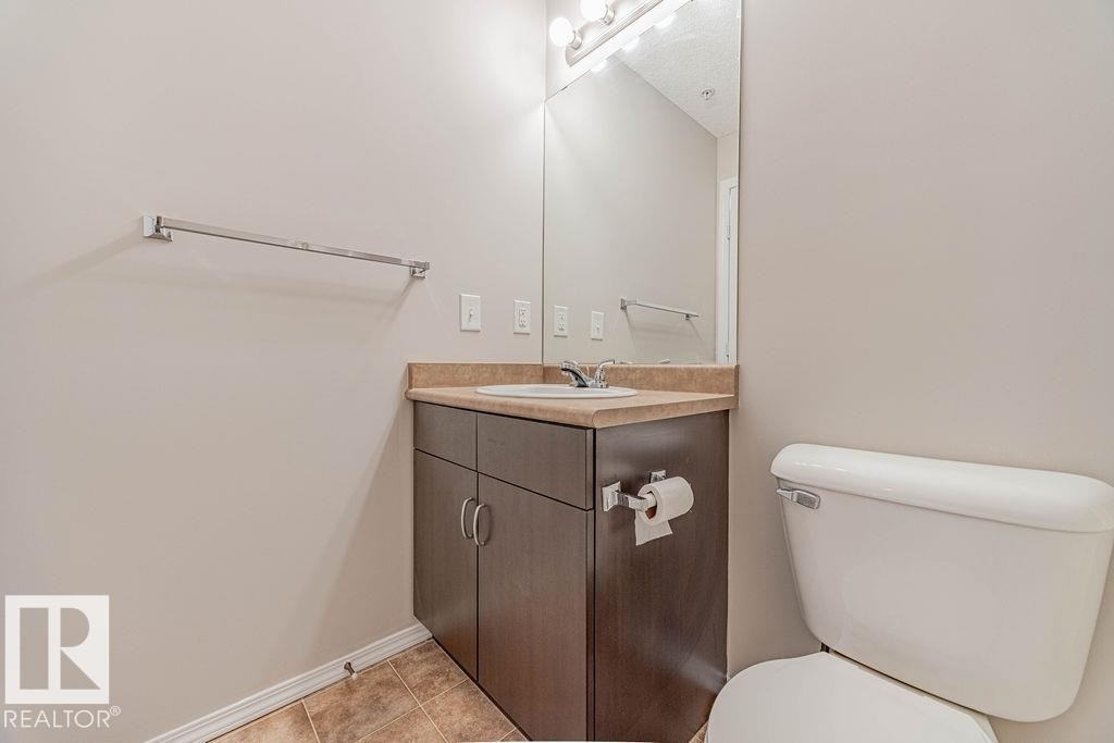 Bathroom with vanity and light tile patterned floors - Edmonton, AB - Indoor Photo Showing Bathroom