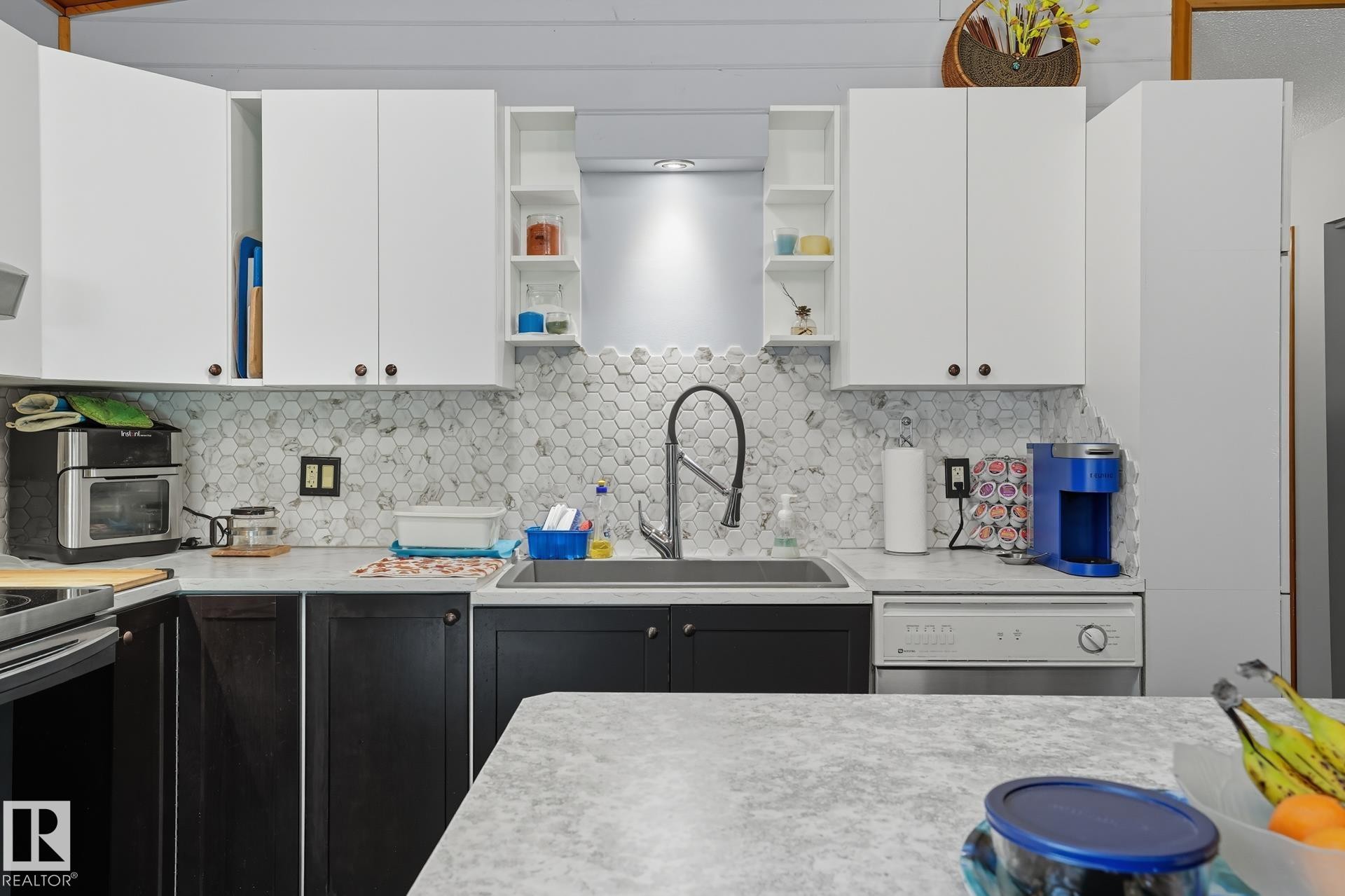 Kitchen featuring open shelves, white cabinets, light countertops, backsplash, and dishwasher - 6309 49 St, Rural Wetaskiwin County, AB - Indoor Photo Showing Kitchen With Upgraded Kitchen