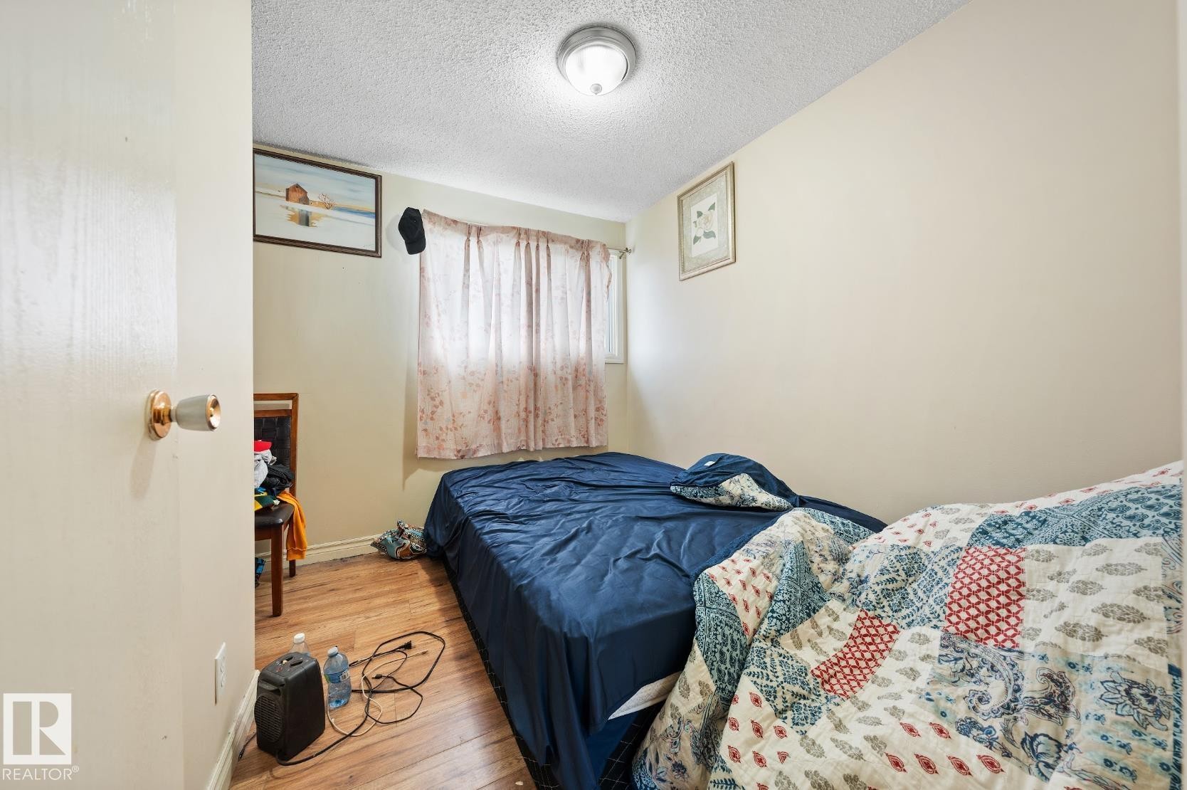 Bedroom featuring wood finished floors and a textured ceiling - 285 Harrison Drive, Edmonton, AB - Indoor Photo Showing Bedroom