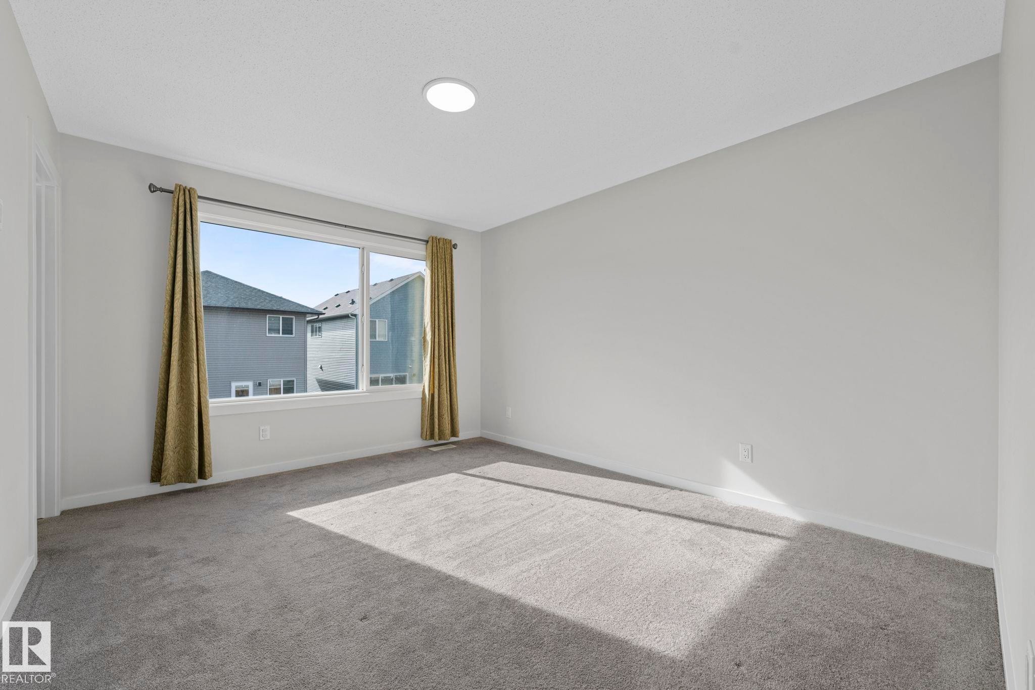 Empty room with carpet floors and baseboards - 1813 Collip View View, Edmonton, AB - Indoor Photo Showing Other Room