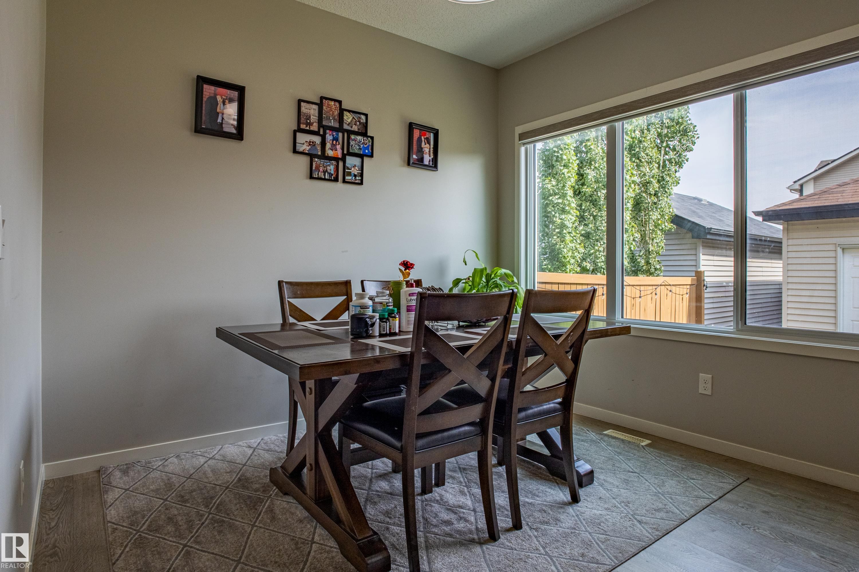 Dining space featuring baseboards and light wood-type flooring - 2407 Casey Link, Edmonton, AB - Indoor