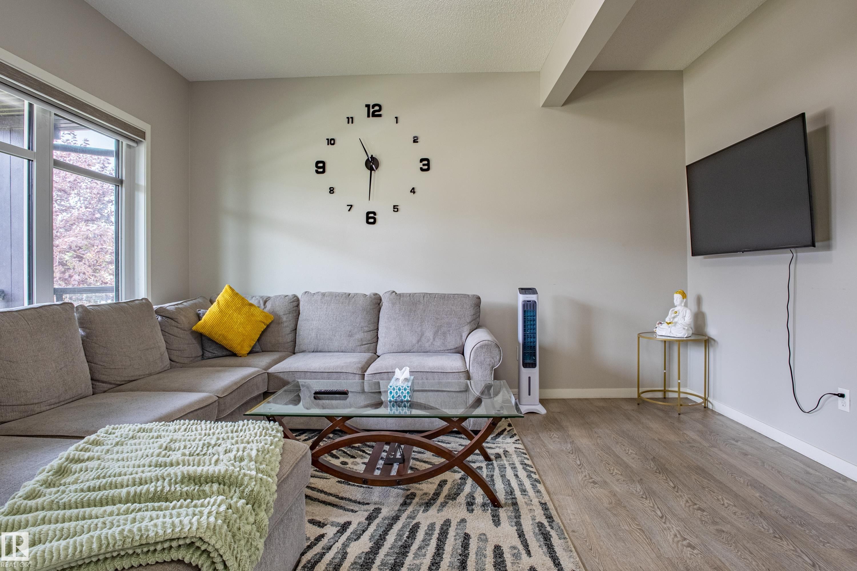 Living area with wood finished floors and beamed ceiling - 2407 Casey Link, Edmonton, AB - Indoor Photo Showing Living Room