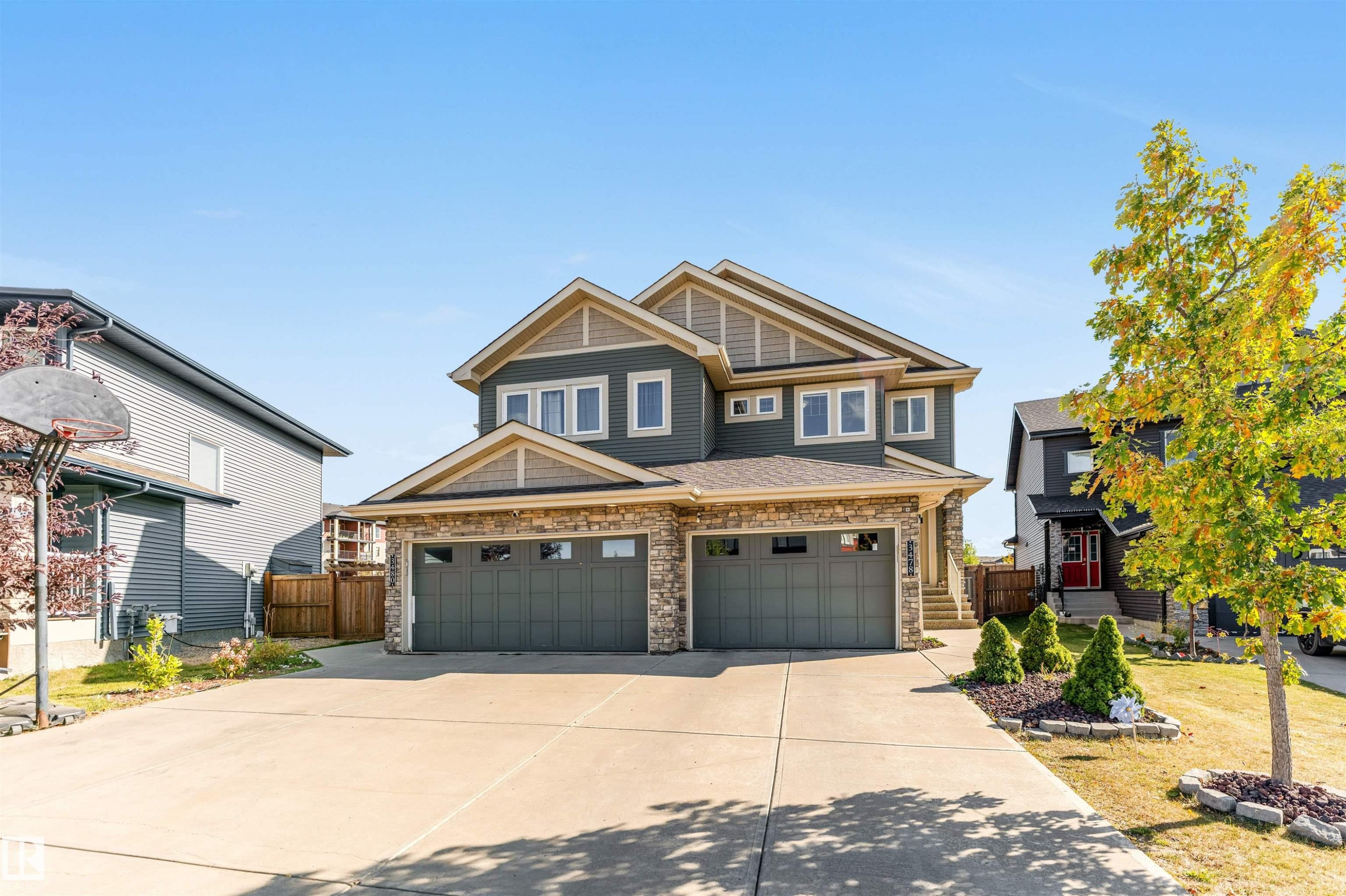 Craftsman-style home with stone siding, driveway, and a garage - 3478 Weidle Way, Edmonton, AB - Outdoor With Facade