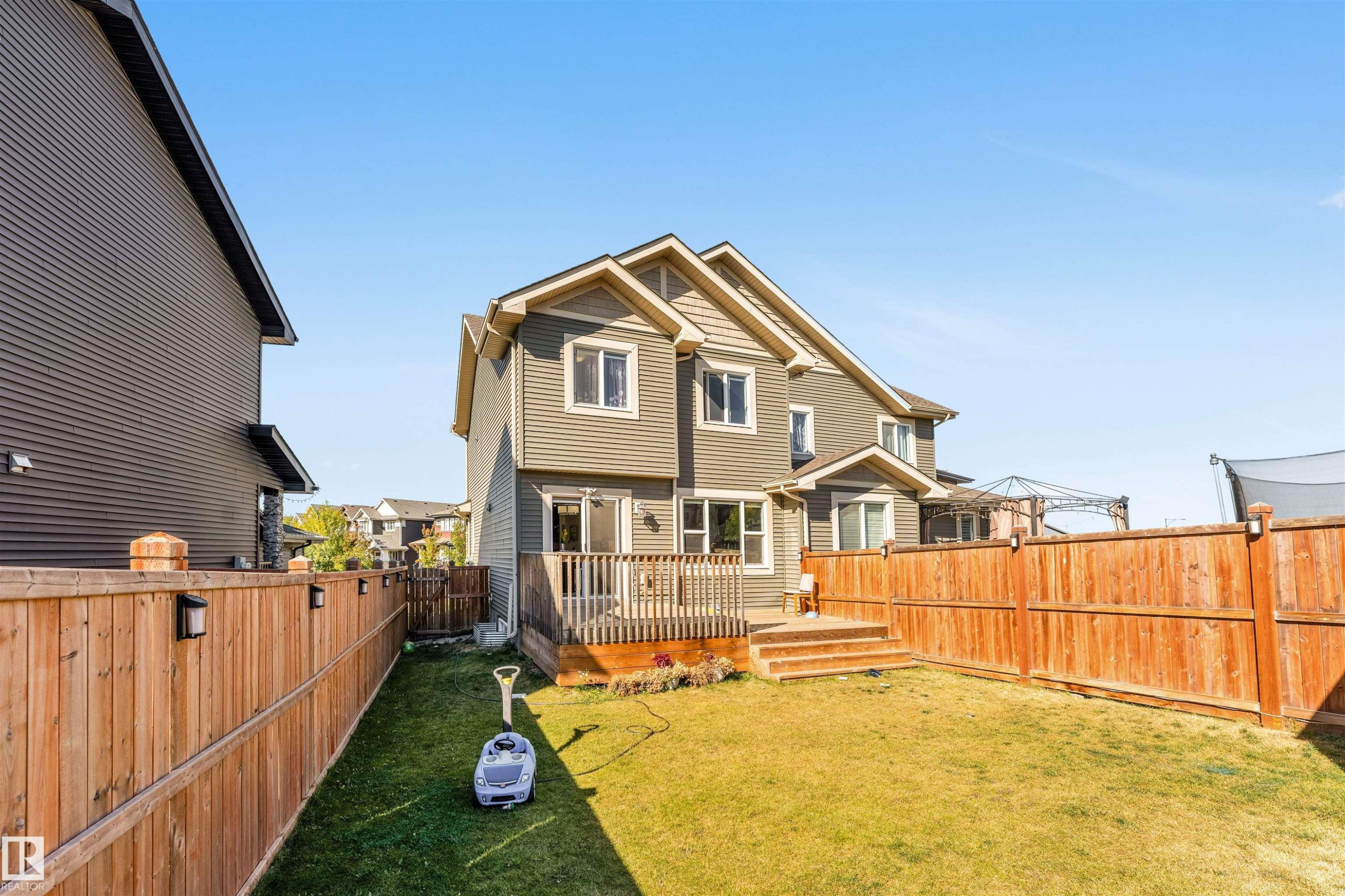 Rear view of property featuring a fenced backyard and a deck - 3478 Weidle Way, Edmonton, AB - Outdoor With Deck Patio Veranda