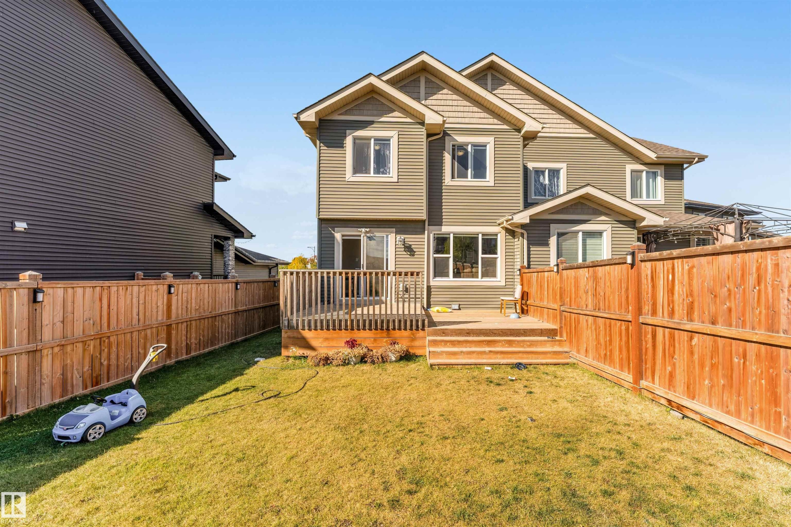 Rear view of house with a fenced backyard and a deck - 3478 Weidle Way, Edmonton, AB - Outdoor