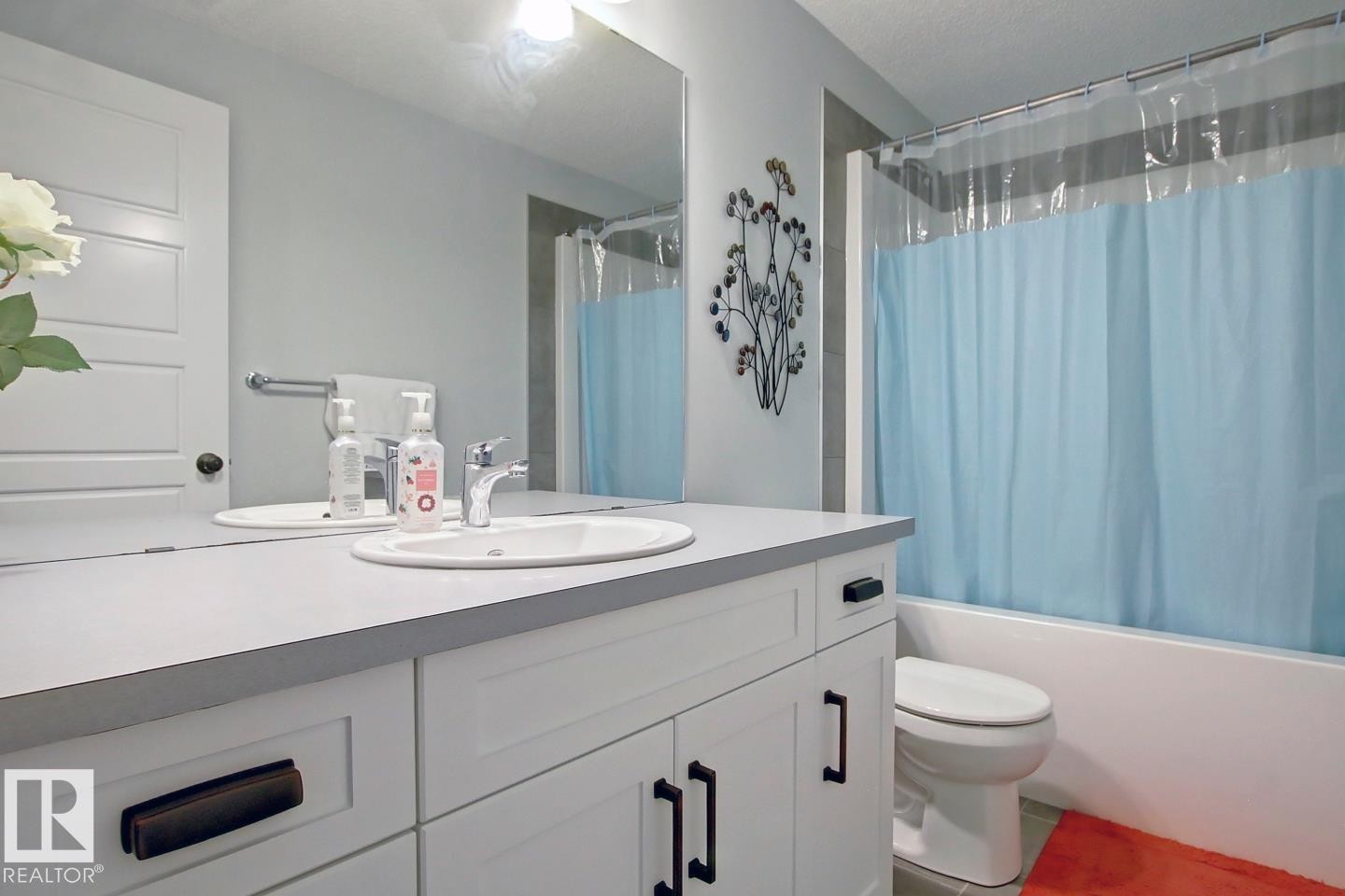 Bathroom with shower / bath combo with shower curtain and vanity - 19633 26A Av, Edmonton, AB - Indoor Photo Showing Bathroom