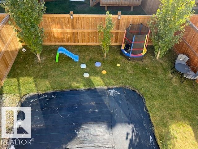 Fenced backyard with a playground - 19633 26A Av, Edmonton, AB - Outdoor