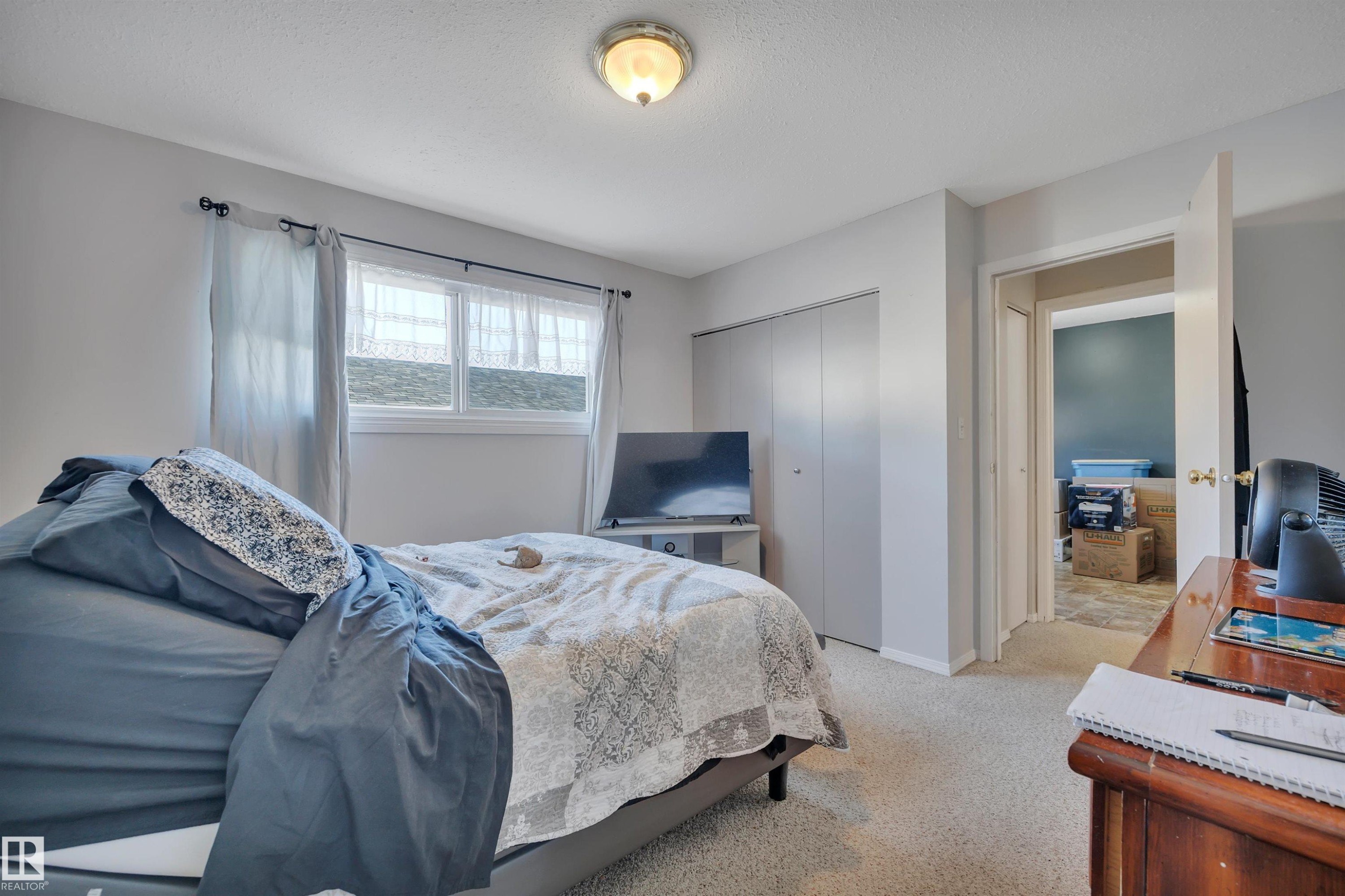 Bedroom featuring light colored carpet and a closet - 5312 36 Ave, Wetaskiwin, AB - Indoor Photo Showing Bedroom