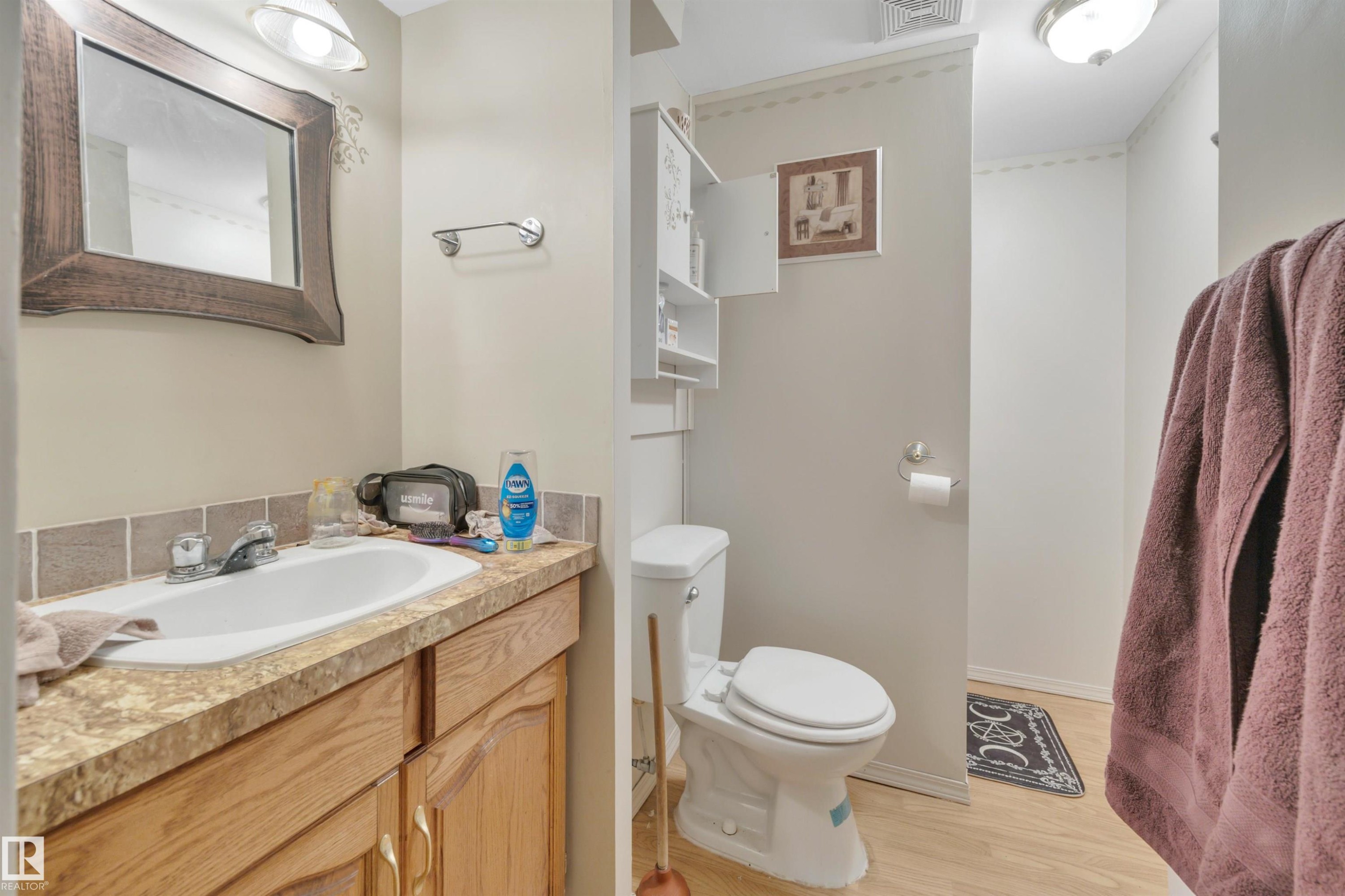Bathroom with vanity and light wood-type flooring - 5312 36 Ave, Wetaskiwin, AB - Indoor Photo Showing Bathroom