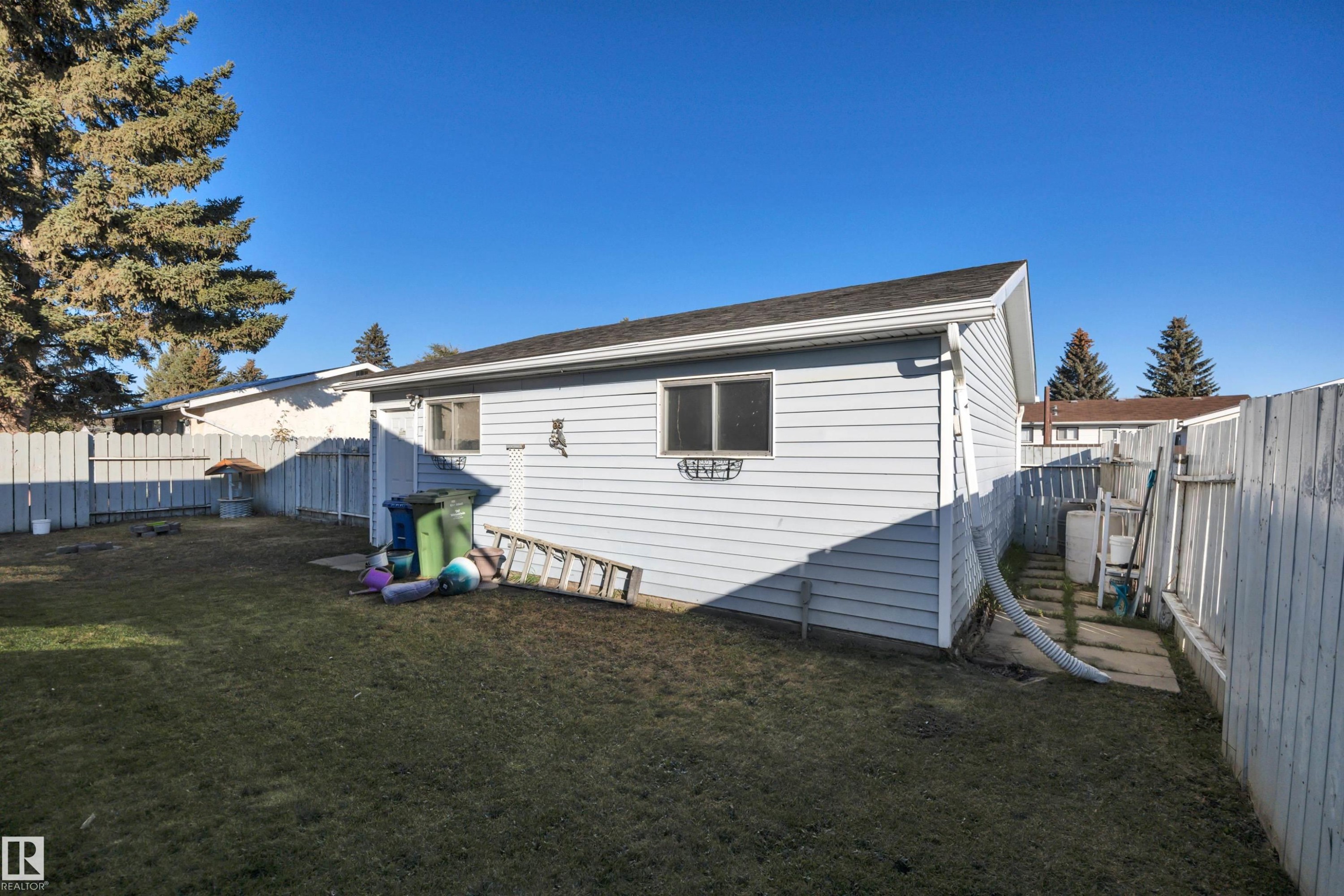 Back of property featuring a fenced backyard and roof with shingles - 5312 36 Ave, Wetaskiwin, AB - Outdoor