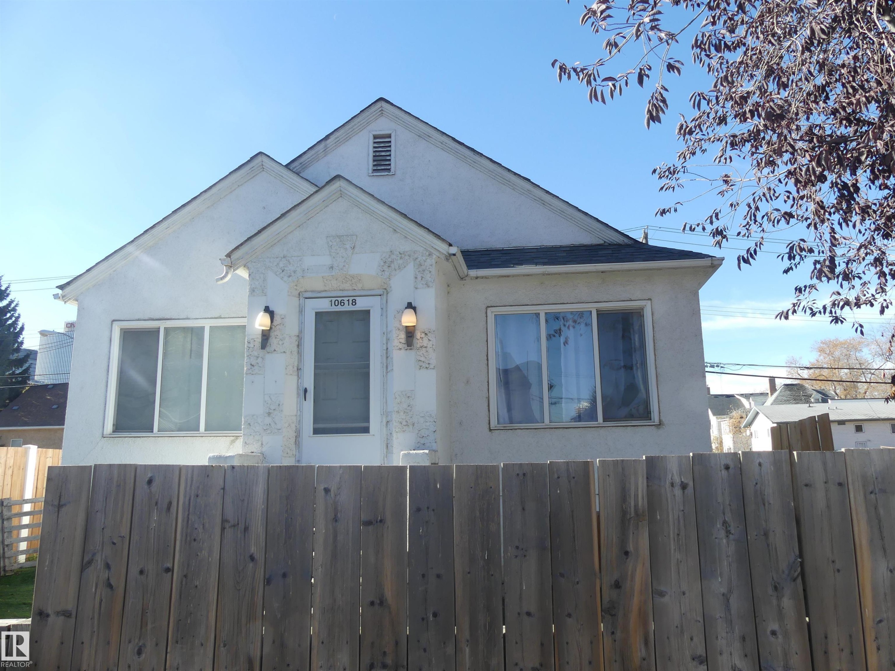 Bungalow-style home featuring a fenced front yard and stucco siding - 10618 96 Street Nw, Edmonton, AB - Outdoor