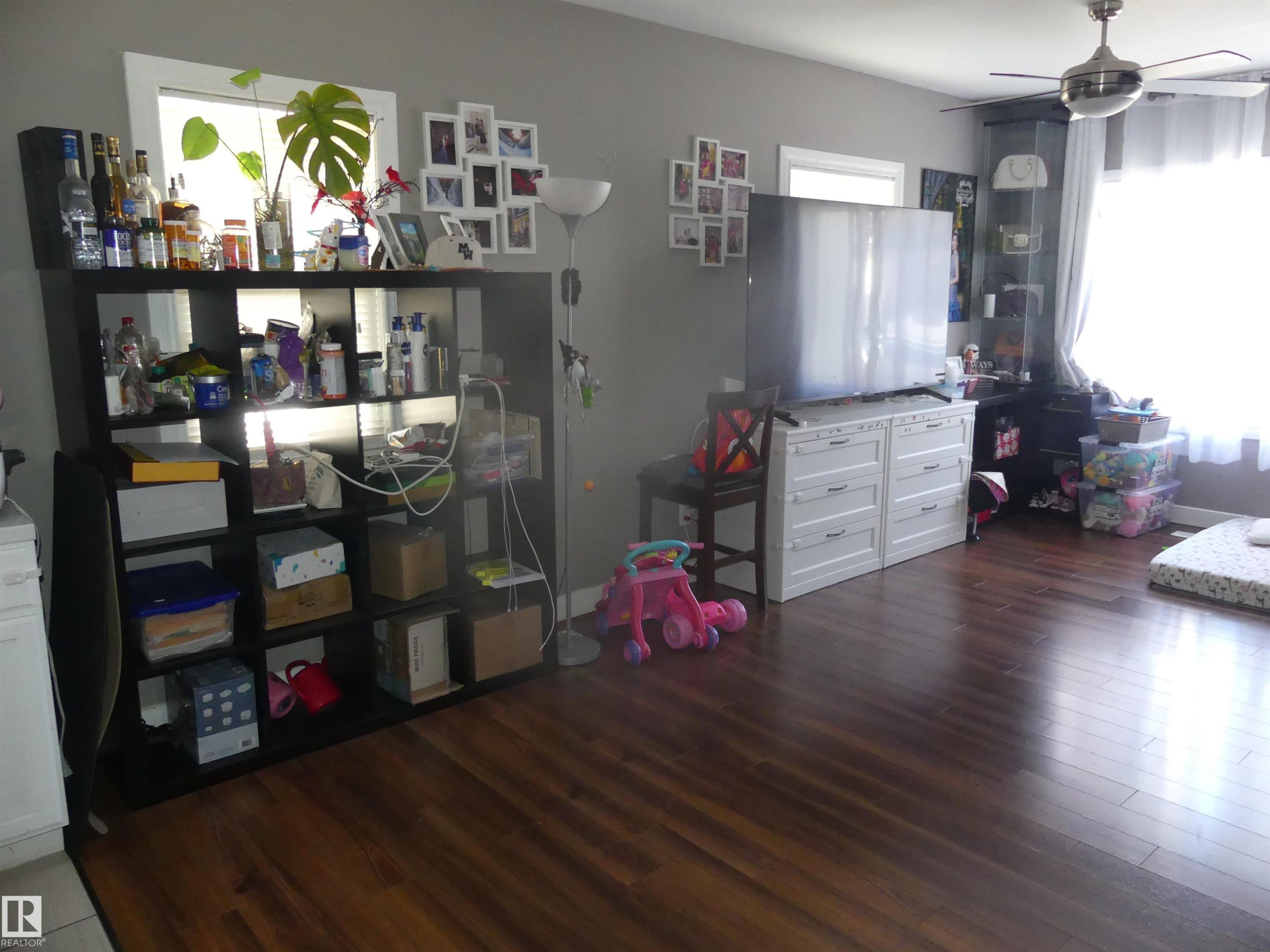 Bedroom featuring dark wood-type flooring and a ceiling fan - 10618 96 Street Nw, Edmonton, AB - Indoor