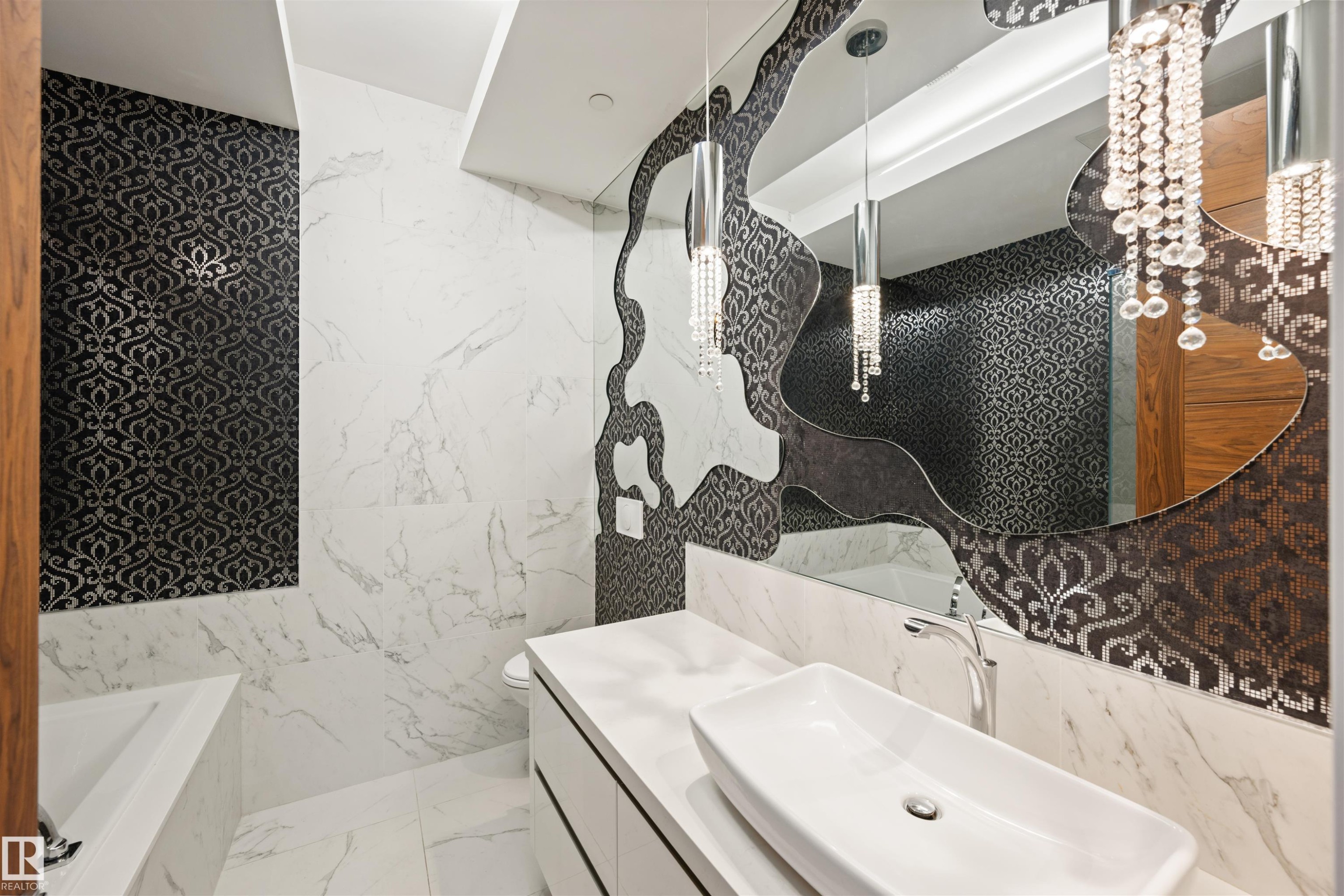 Full bathroom with tile walls, a bathtub, vanity, and light marble finish floors - 3201 11969 Jasper Avenue, Edmonton, AB - Indoor Photo Showing Bathroom