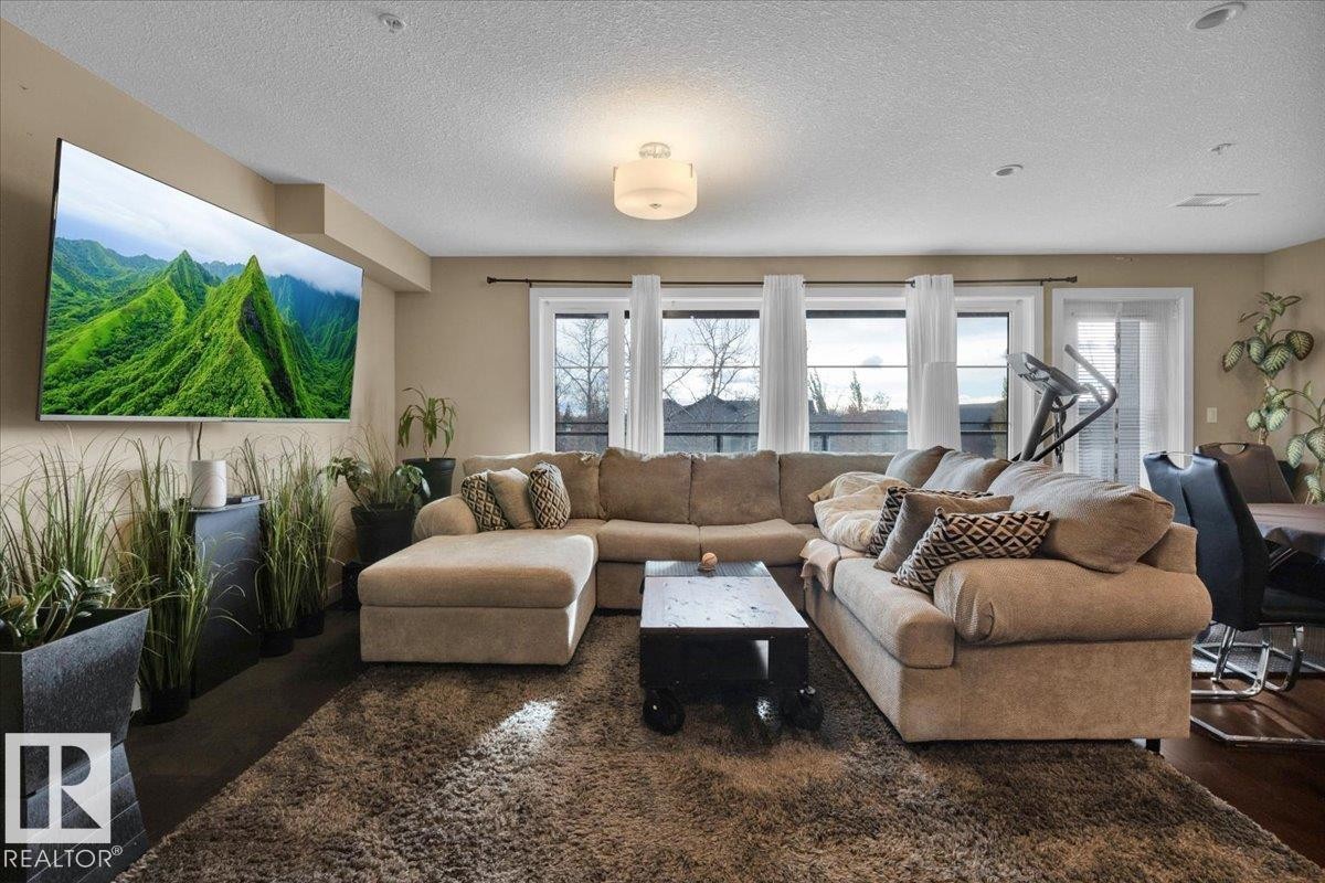 Living room with a textured ceiling - 305 5029 Edgemont Boulevard, Edmonton, AB - Indoor Photo Showing Living Room