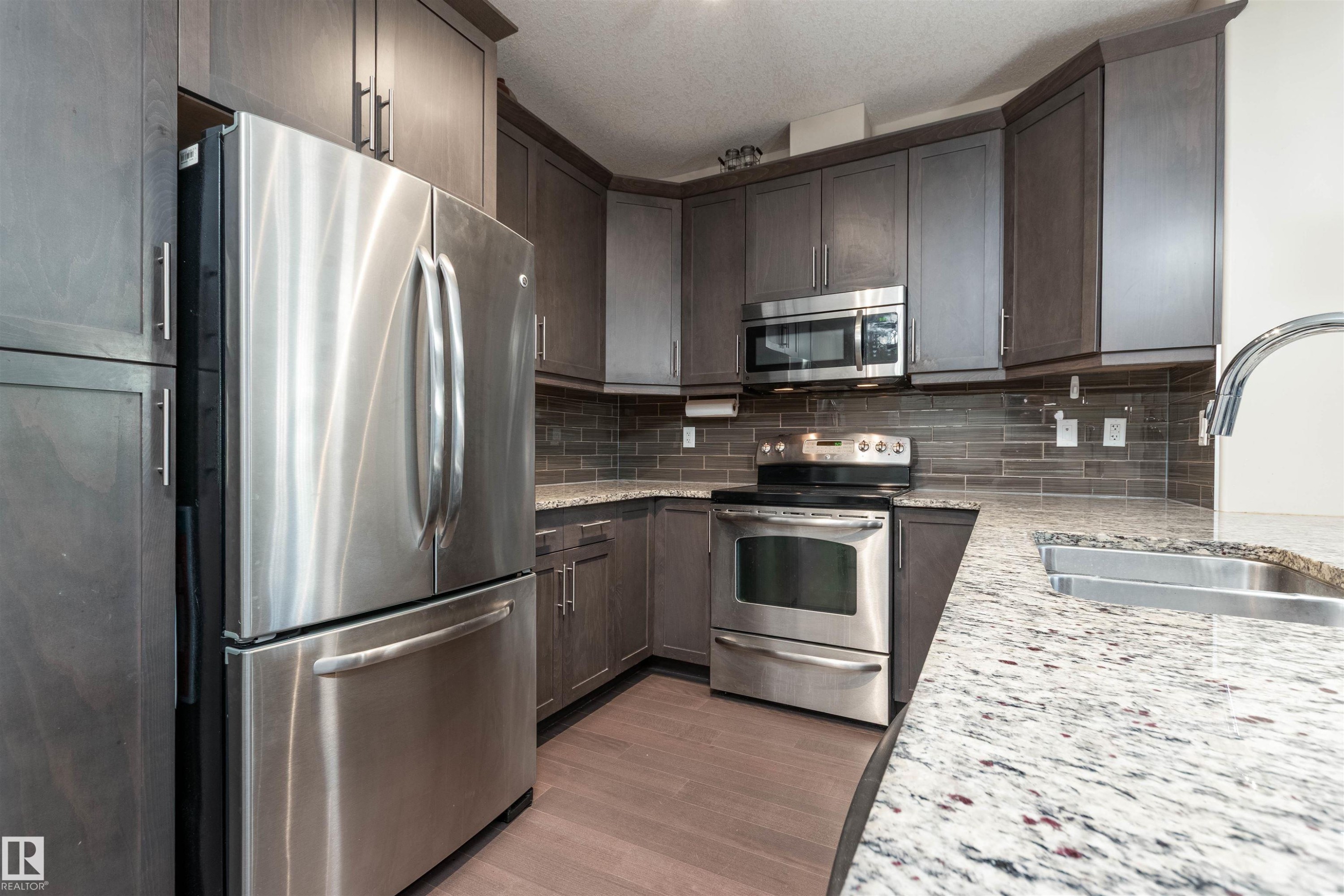 Kitchen with stainless steel appliances, - 140 6079 Maynard Way, Edmonton, AB - Indoor Photo Showing Kitchen With Double Sink With Upgraded Kitchen