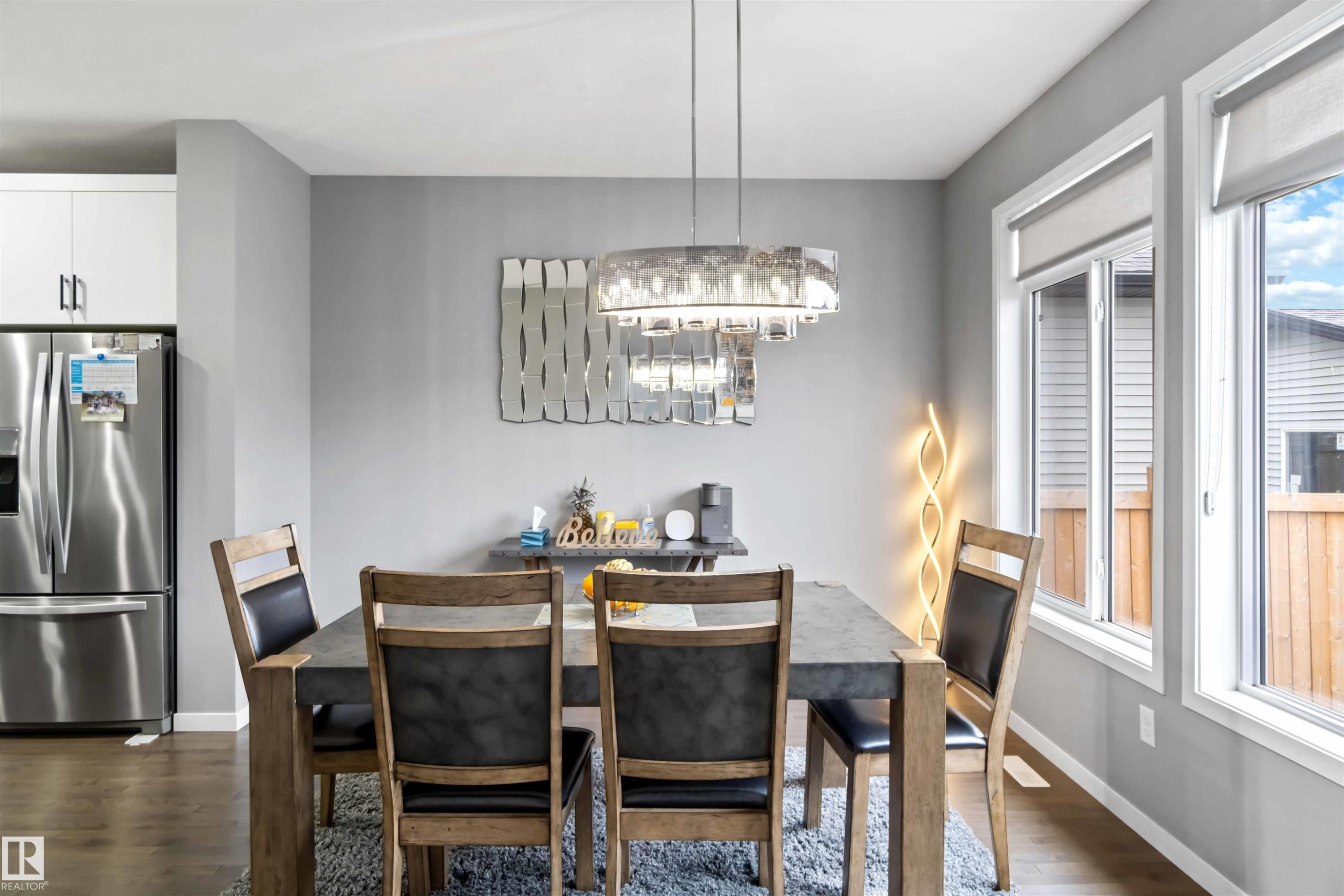 Dining space with dark wood finished floors and a chandelier - 17816 59 Street, Edmonton, AB