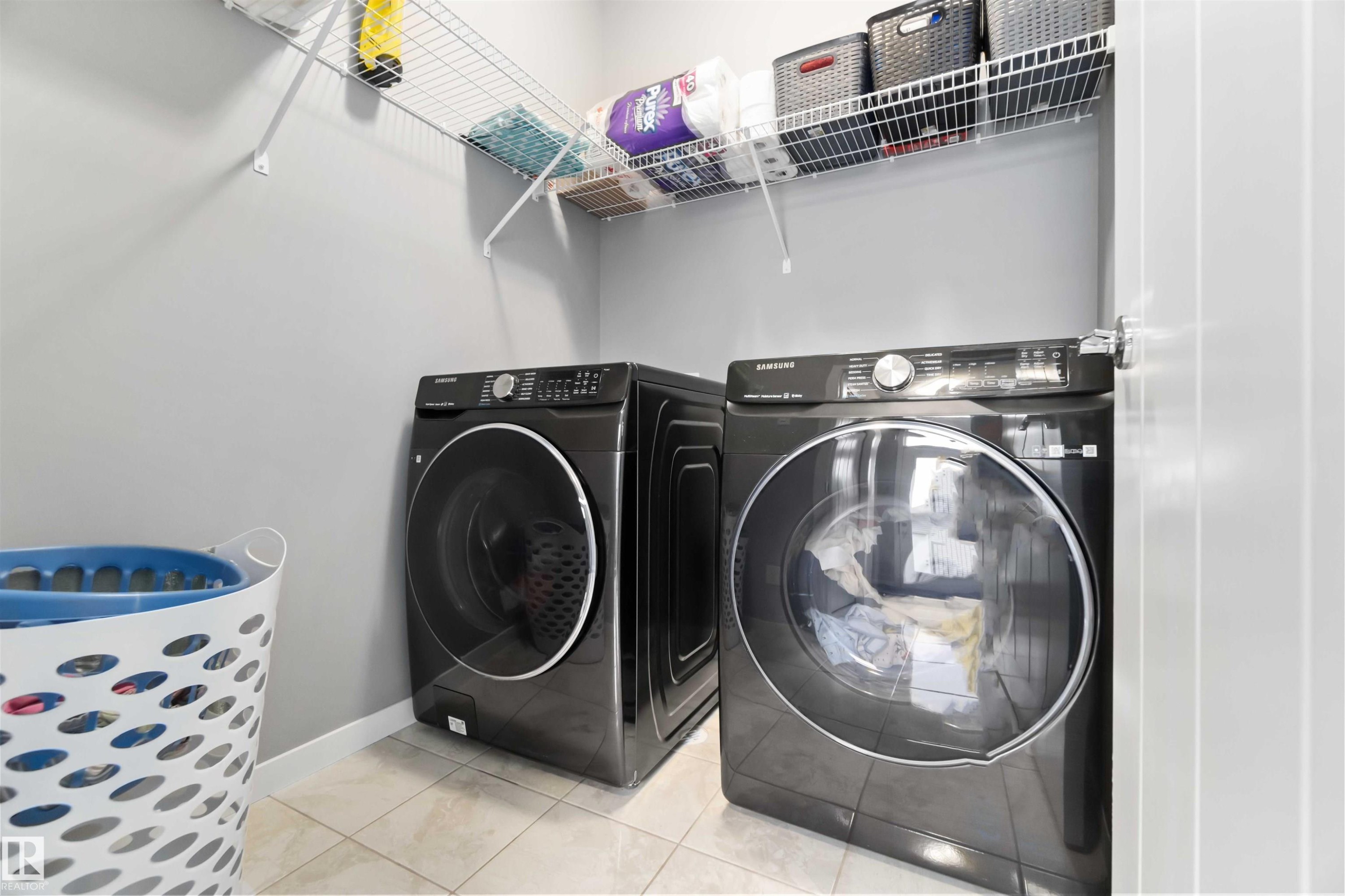 Laundry area with tile patterned floors and independent washer and dryer - 17816 59 Street, Edmonton, AB