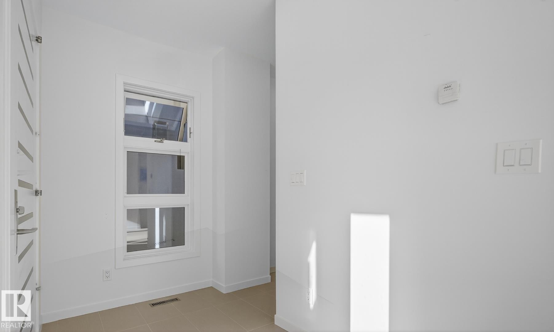 Unfurnished room with light tile patterned floors and baseboards - 14502 103 Avenue, Edmonton, AB - Indoor Photo Showing Other Room